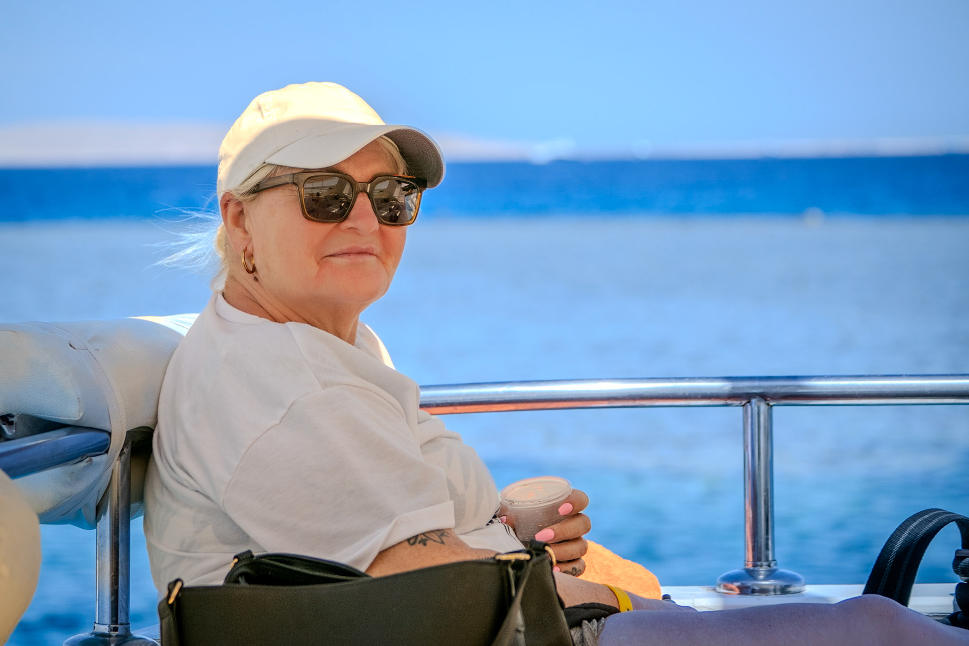 Lady in sunglasses on a boat in the Red Sea