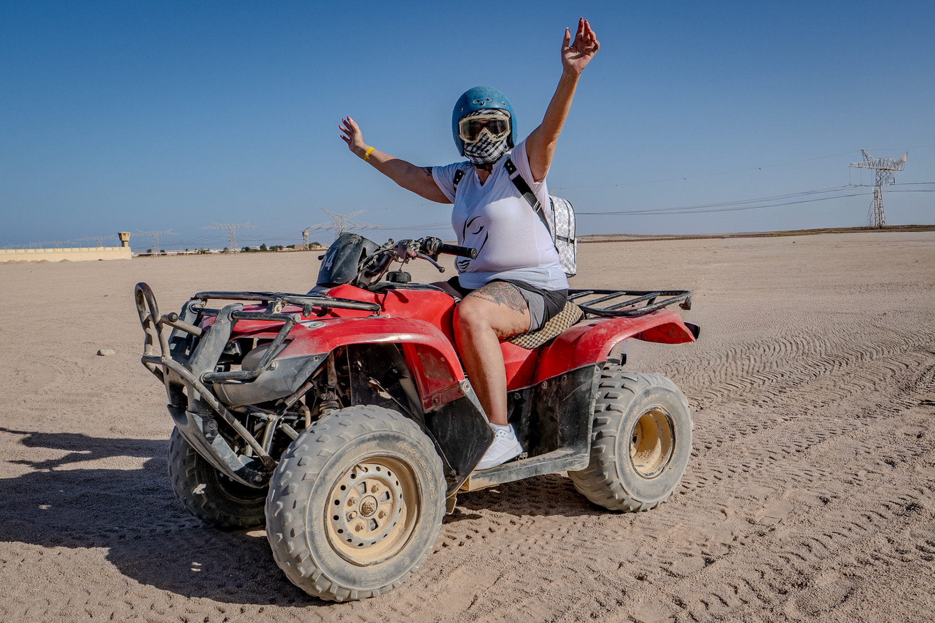 Lady waving her arms in the air whilst riding on quad biles