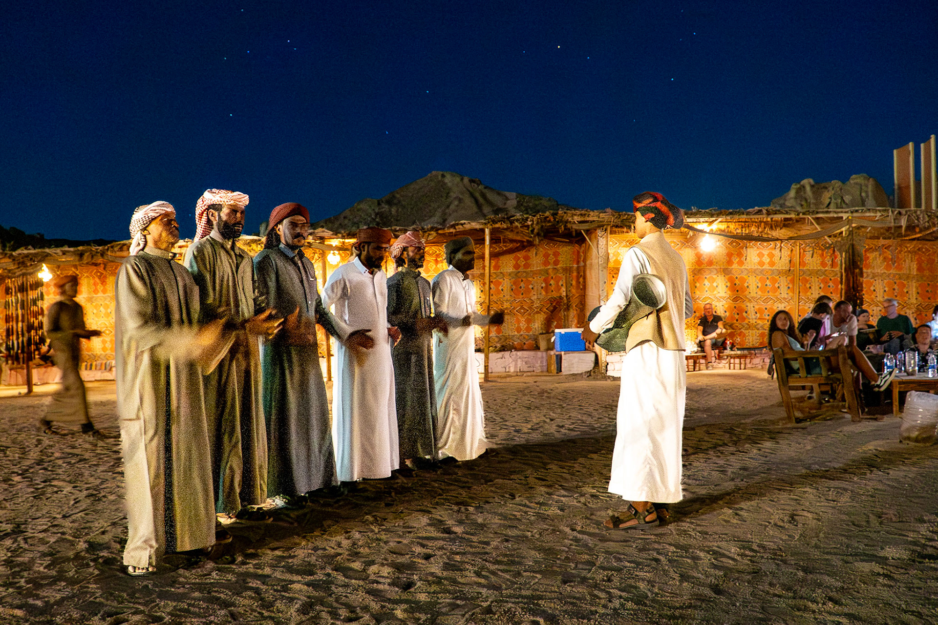 Bedouin men singing at dinner in the desert
