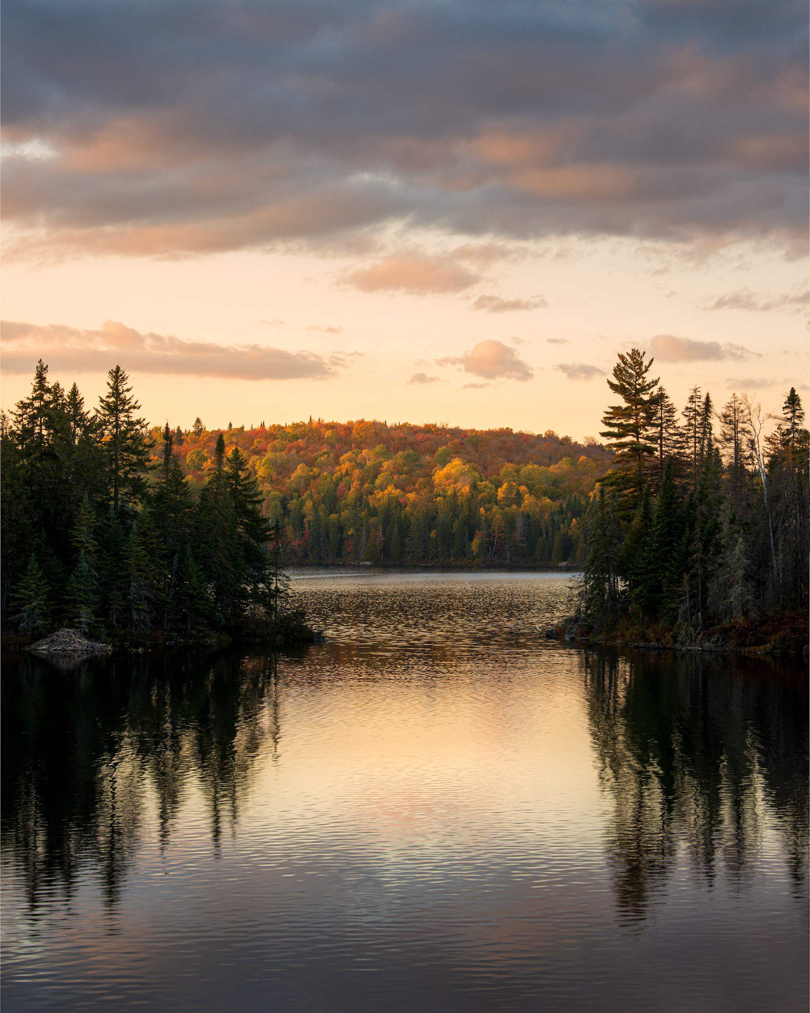 This another image out of an autumnal series from my fall trip to the Mauricie National Park during this past fall. I had scouted a location on the map that was promising for sunset around Lake Écarté, but when I was on location, I realized that the access to the lac was almost impossible, anywhere, but by boat. Discomfiture... hardly convinced that I would capture an image this evening, I was driving back to the camp when I spotted this passage from the road. I frantically searched for a location to park and rushed back to face the passage and grab this view just before the sun disappeared behind the horizon.