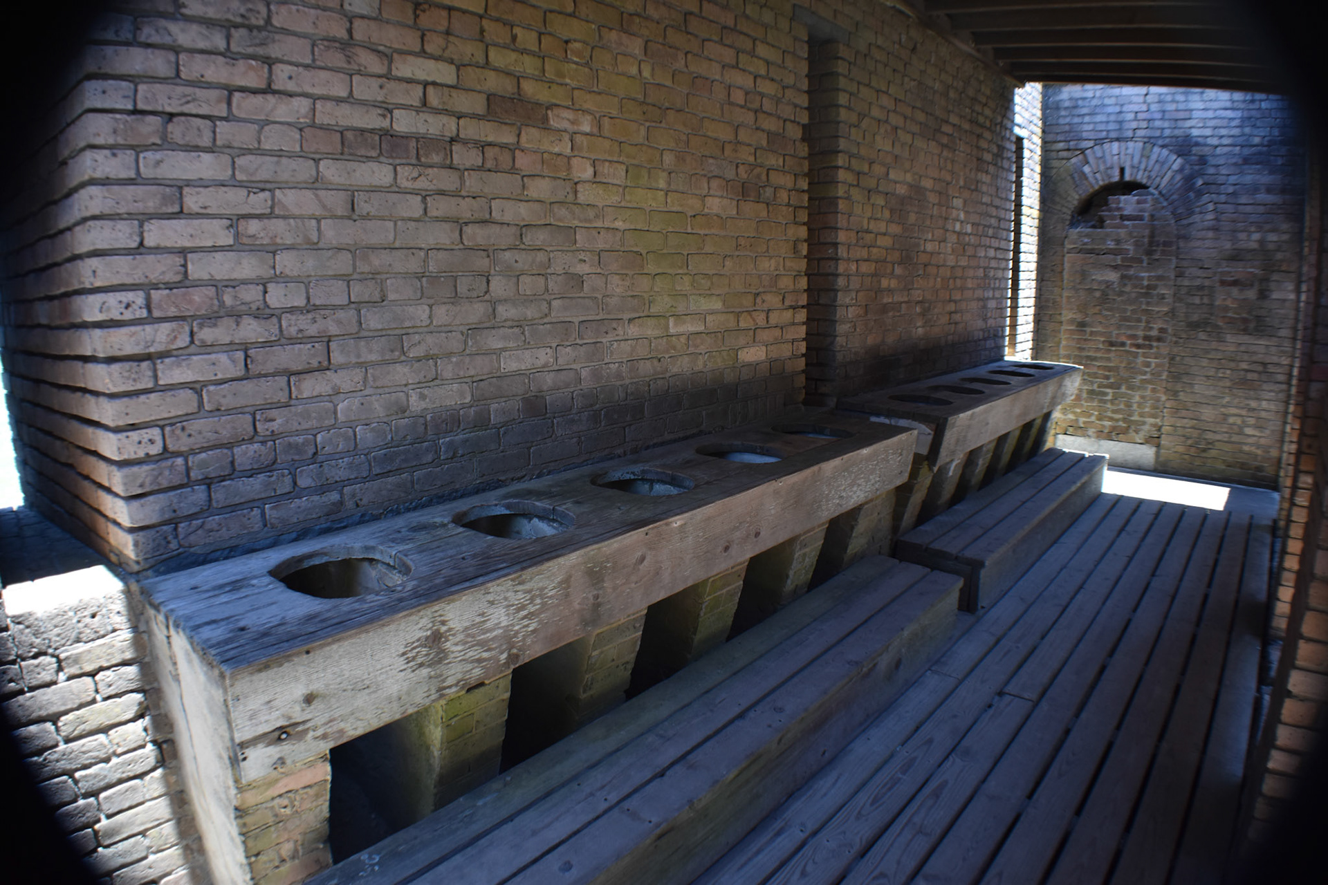 Latrines flushed by tidal outlet