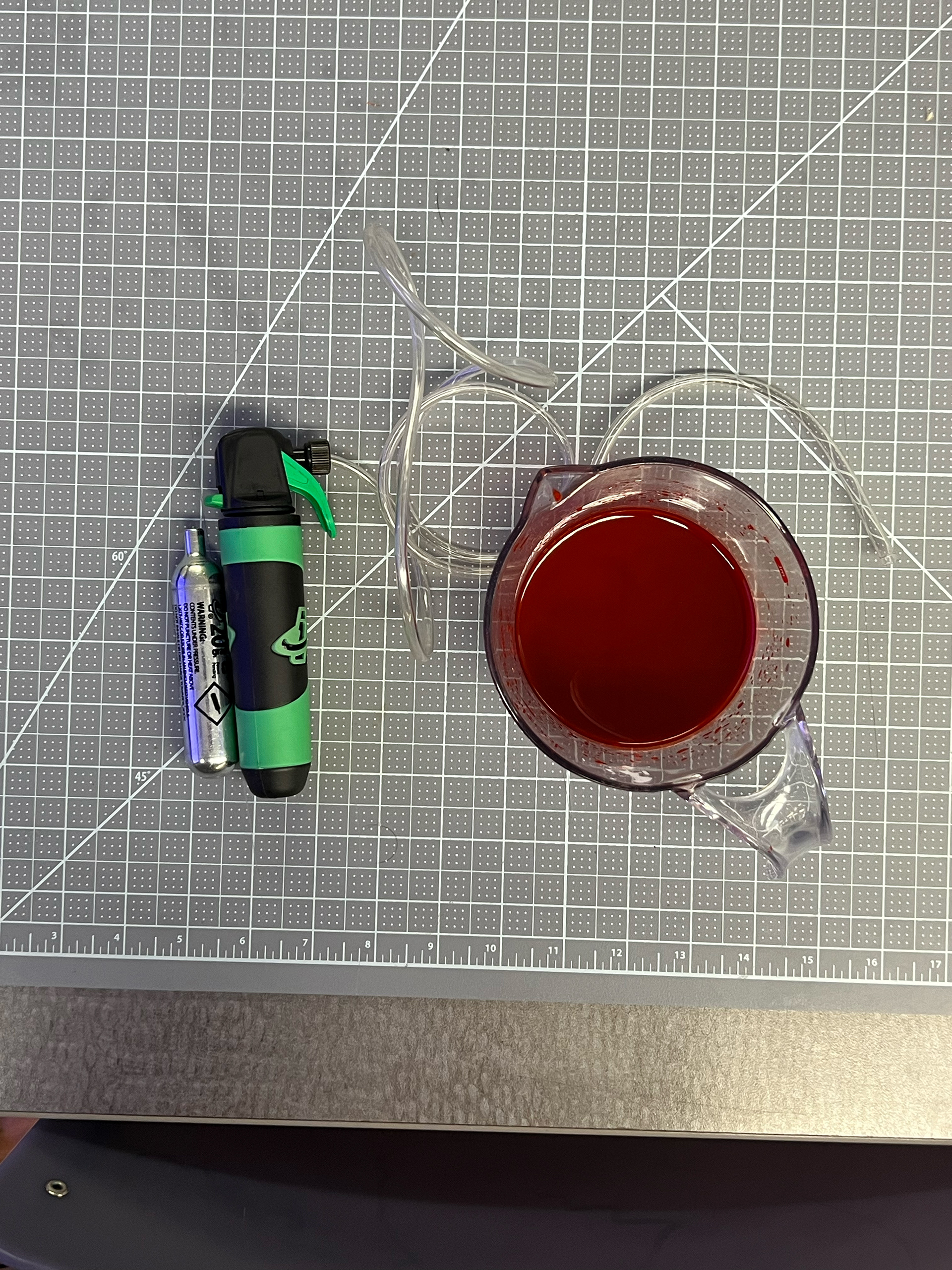 Co2 bike tire inflator, connected to clear tubing and stage blood. 