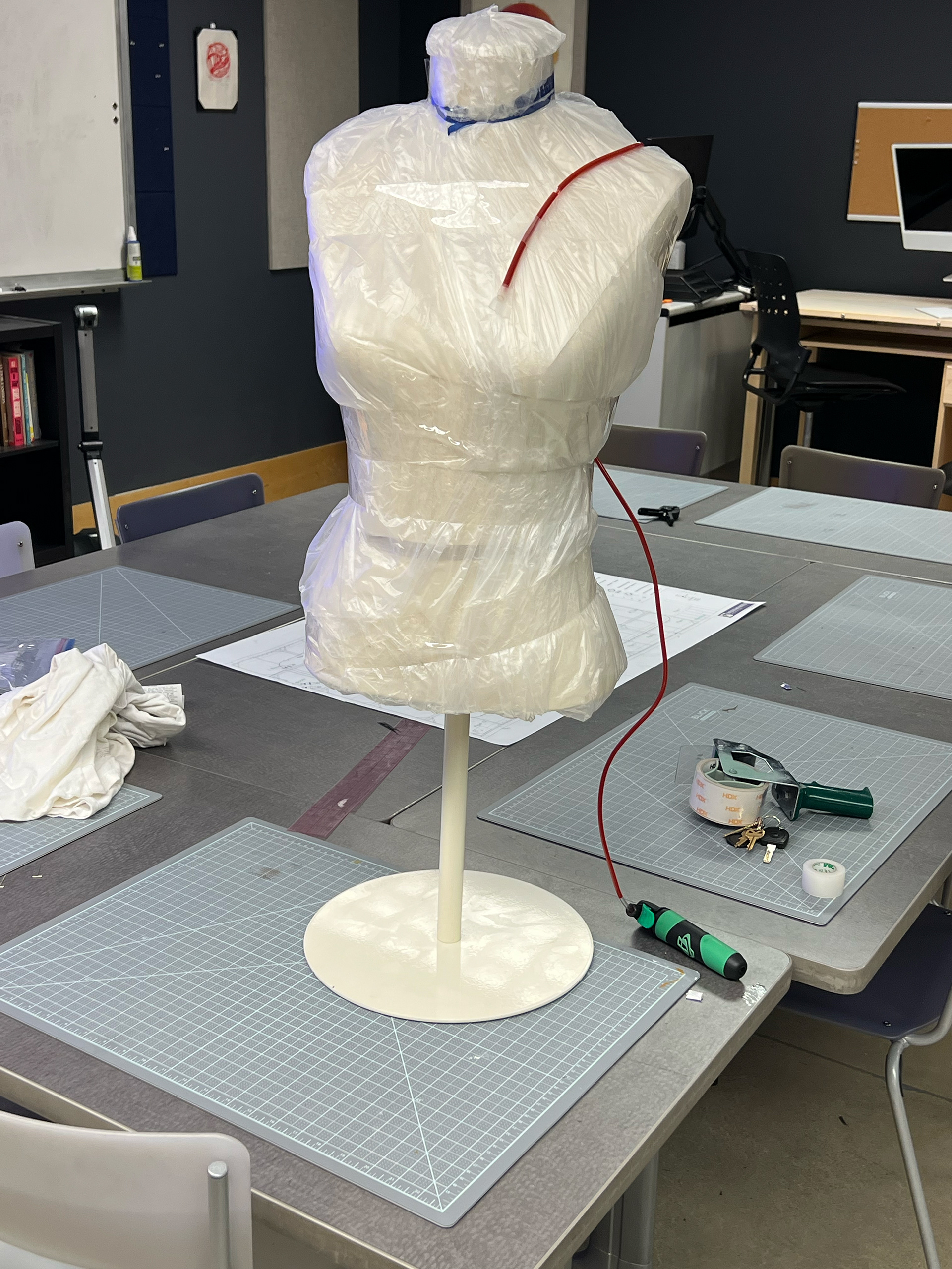 Tubing filled with stage blood and placed on mannequin for demo