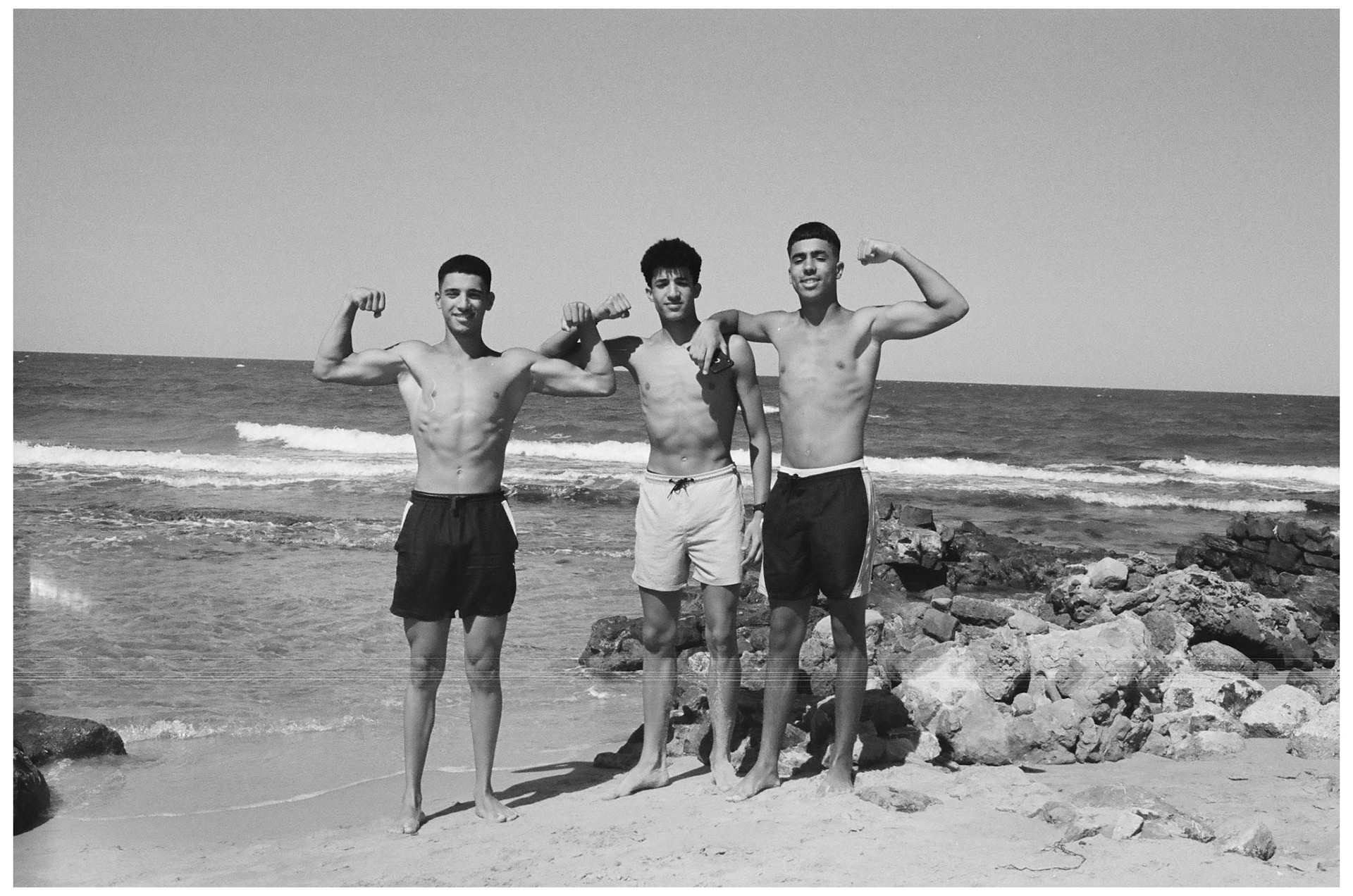 Des jeunes hommes se pavanant sur la plage à Marsa.