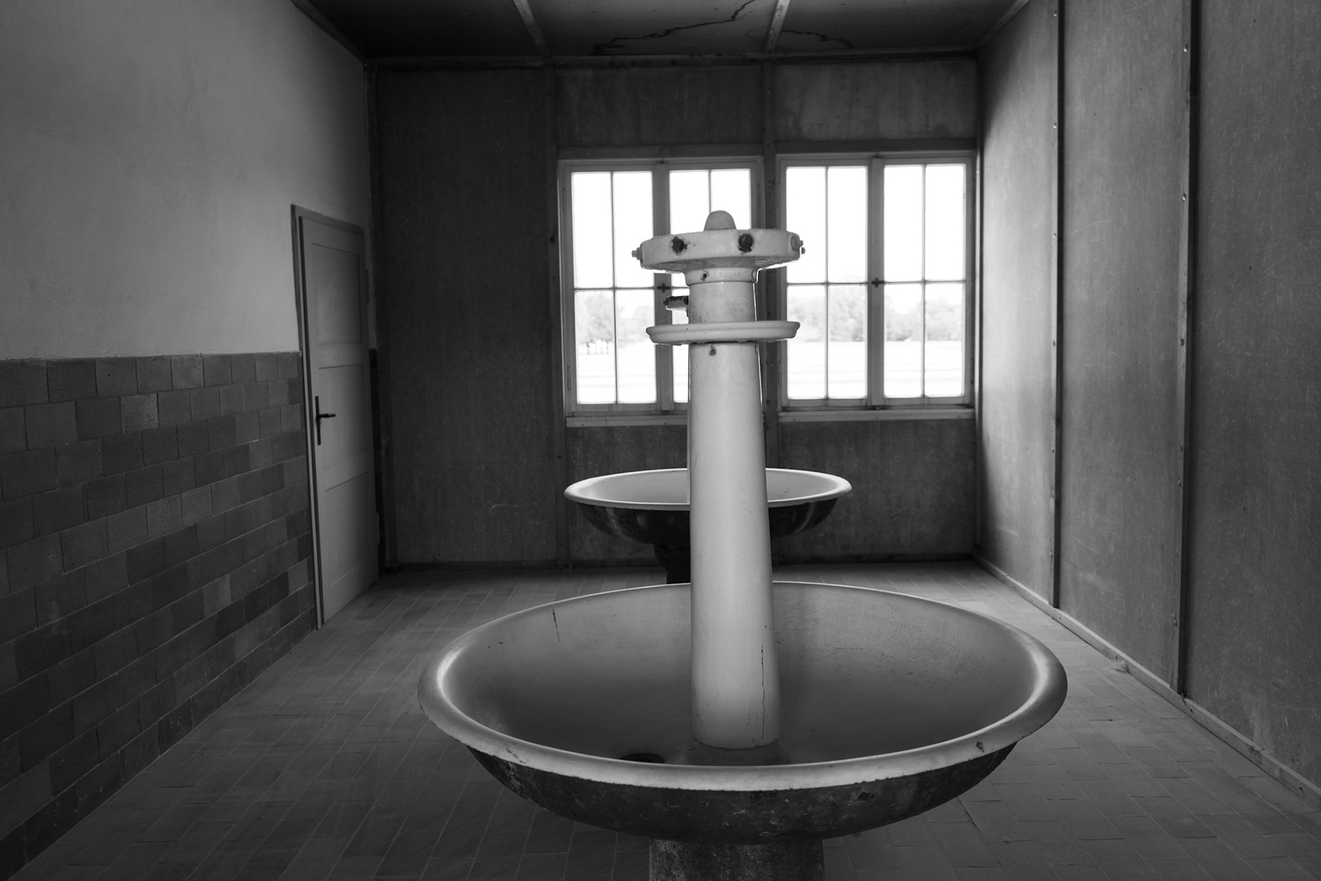 This is the only washroom each barrack had. Two basins were originally intended to support over 90 prisoners.