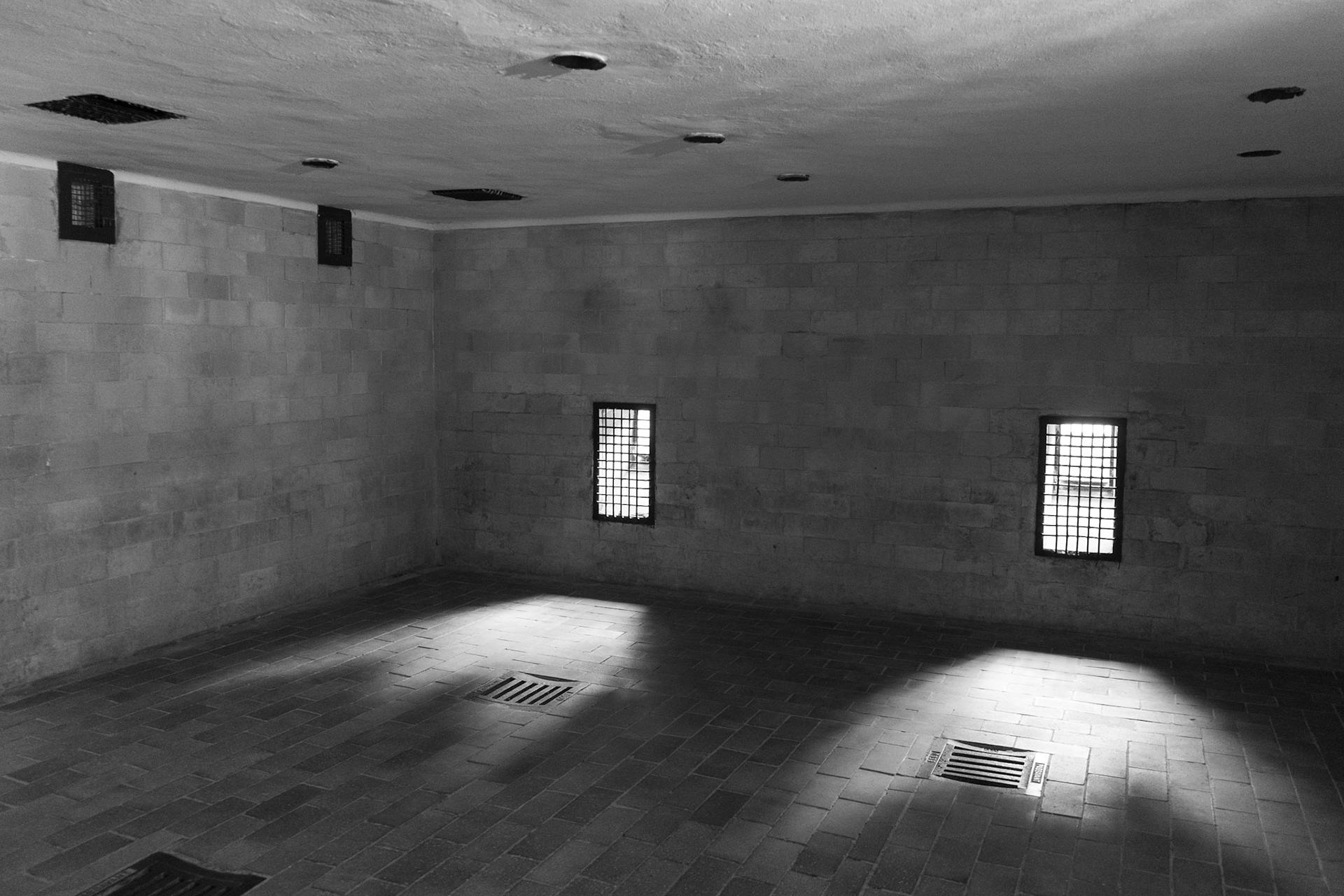 This is the room where they were gassed. The shower heads in the ceiling were not operational and were there for a ruse. All the shower heads except one have been stolen. The gas actually filled the room from the vents in the floor.