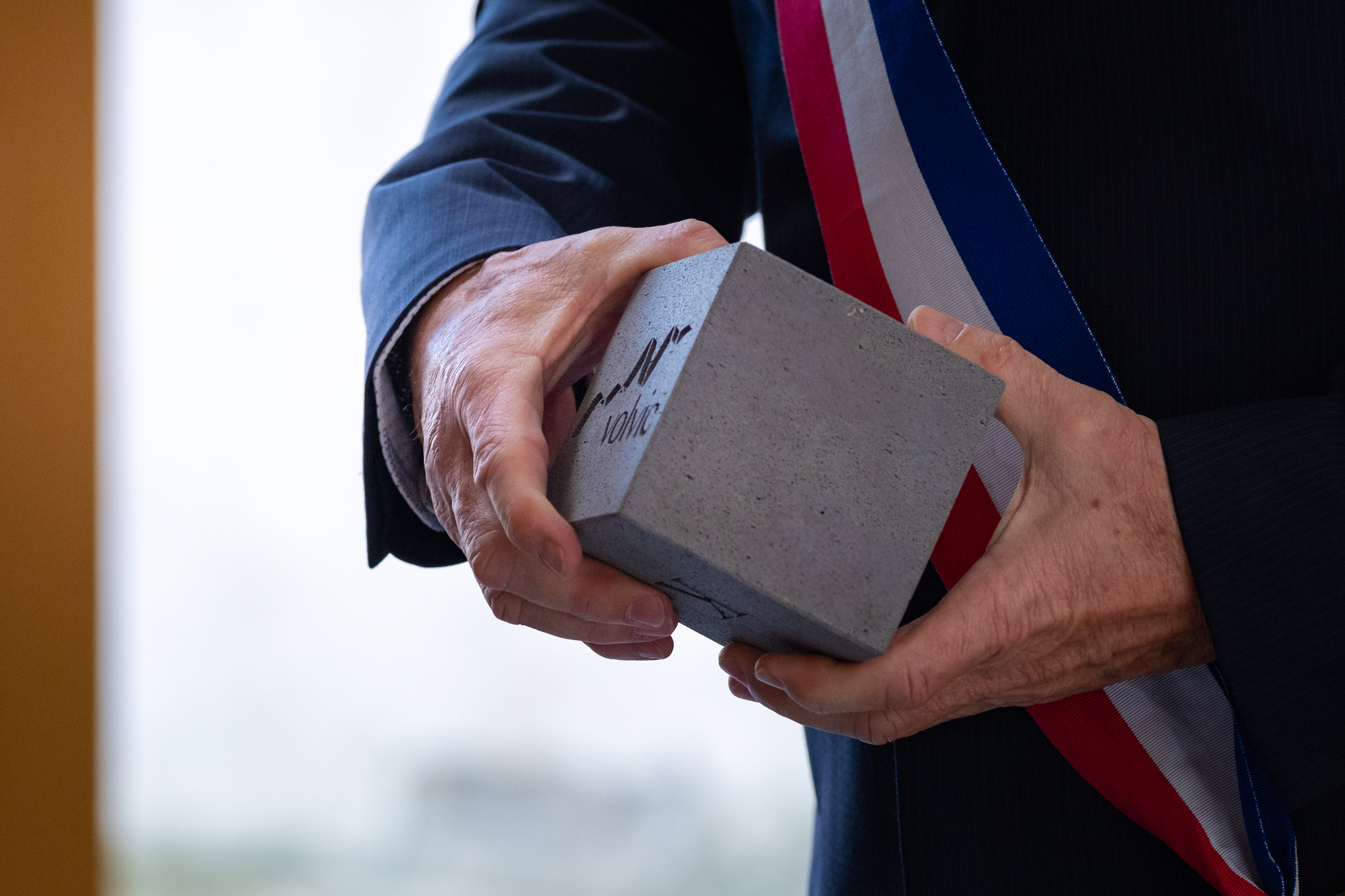 Laurent Thévenot holding Volvic's lava, a rare kind of stone, made from local artist Thierry Courtadon