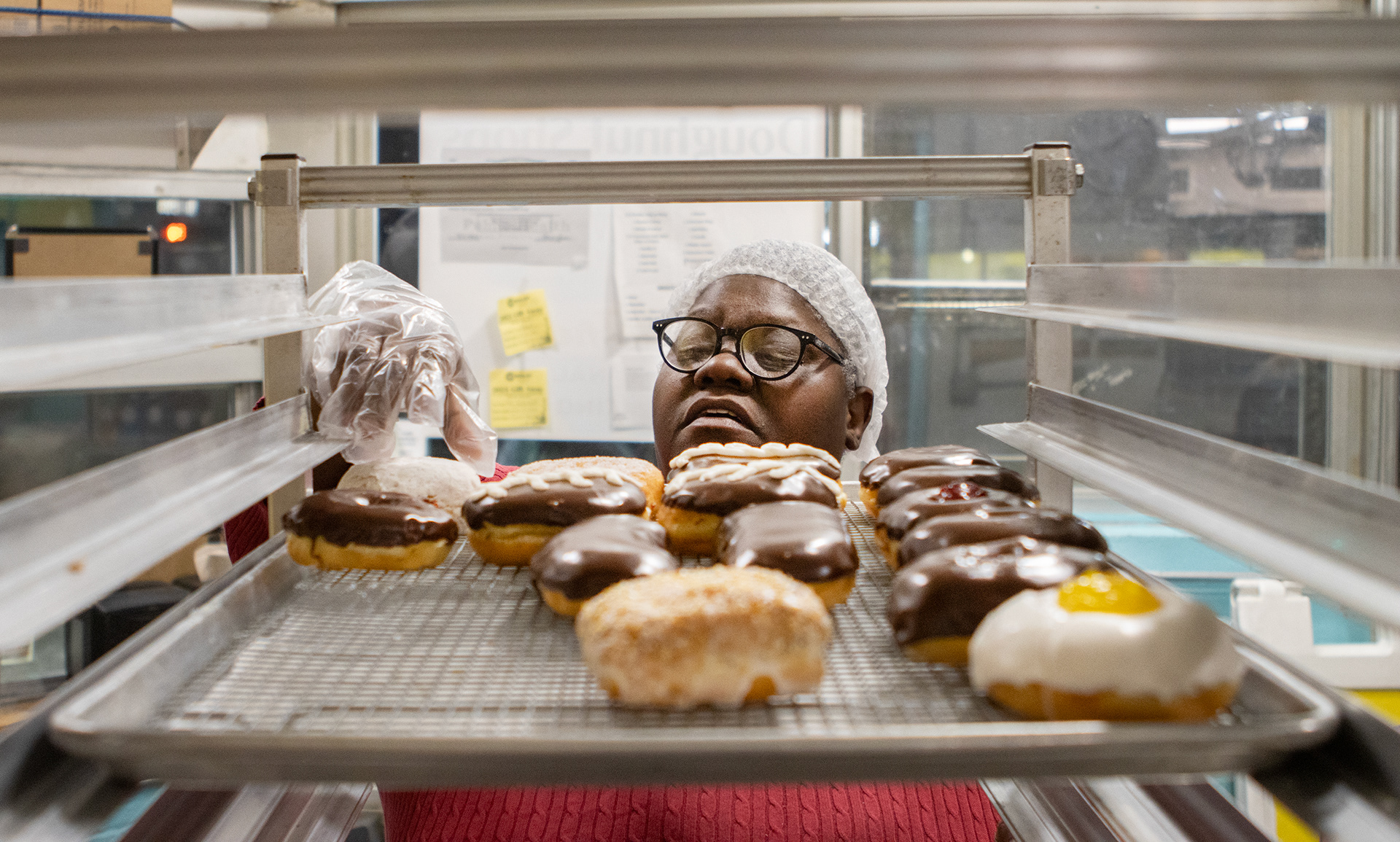 The owner of Revival City Doughnuts, Marschelle McCoy, takes out a tray of doughnuts from the cart and gives advice on what went wrong and what could have been better with the doughnuts to her employee Bronica Bazzano at Revival City Doughnuts on Feb. 8.
