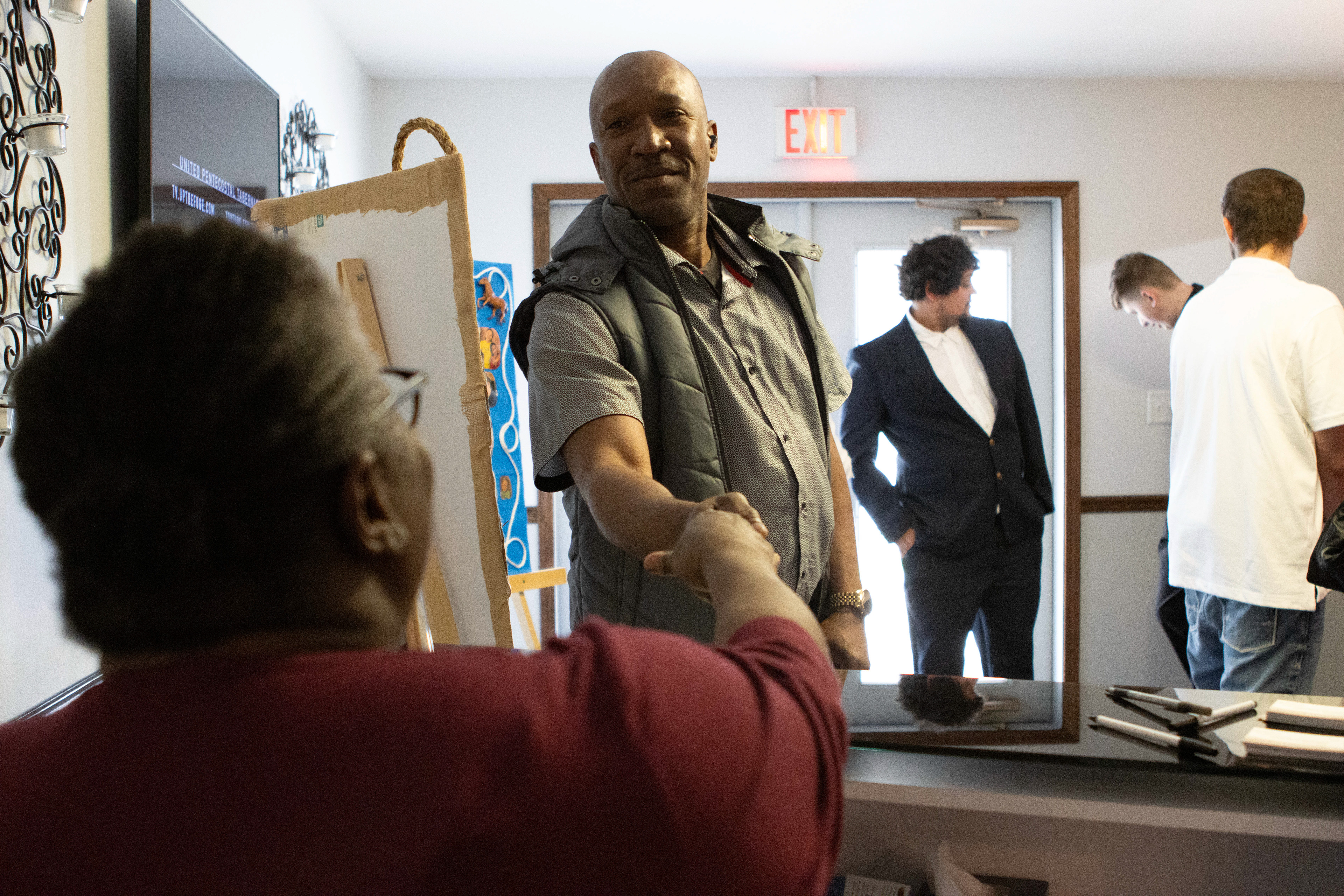 James Nicolas greets Marschelle McCoy at the United Pentecostal Tabernacle church on March 31.