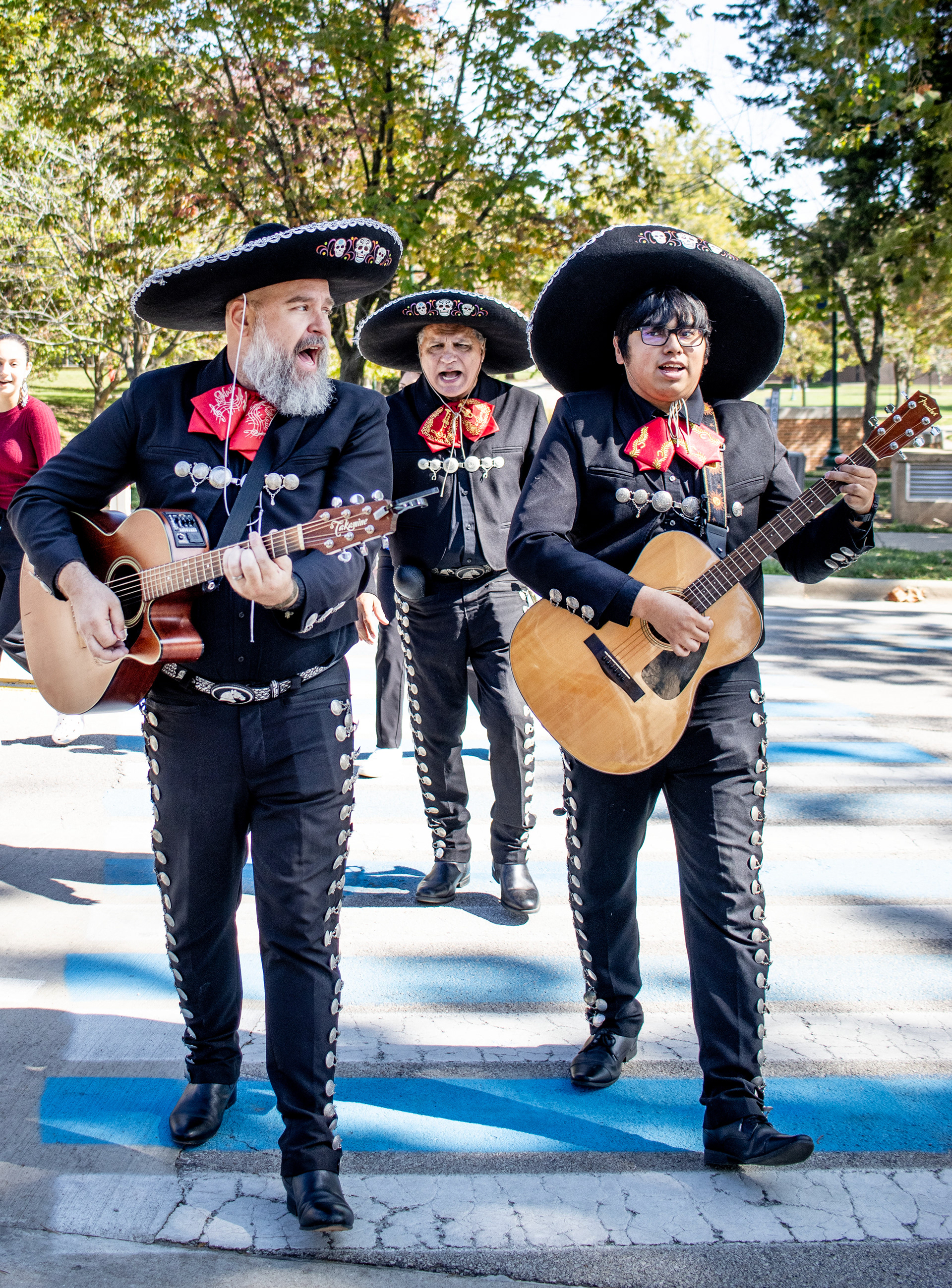 Los Amigos band walk across the street to continue playing at Stevenson Dining Hall