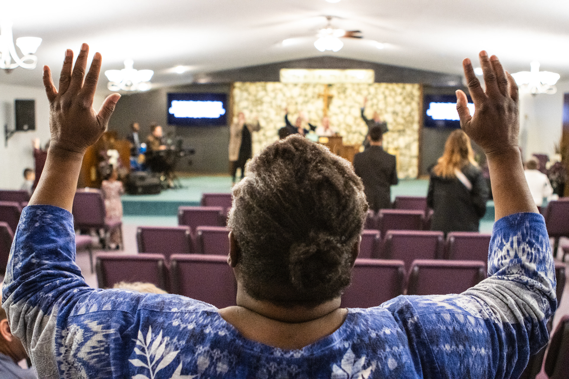 Marschelle McCoy raises her arms in praise during Wisdom Wednesday service at United Pentecostal Tabernacle Feb. 28