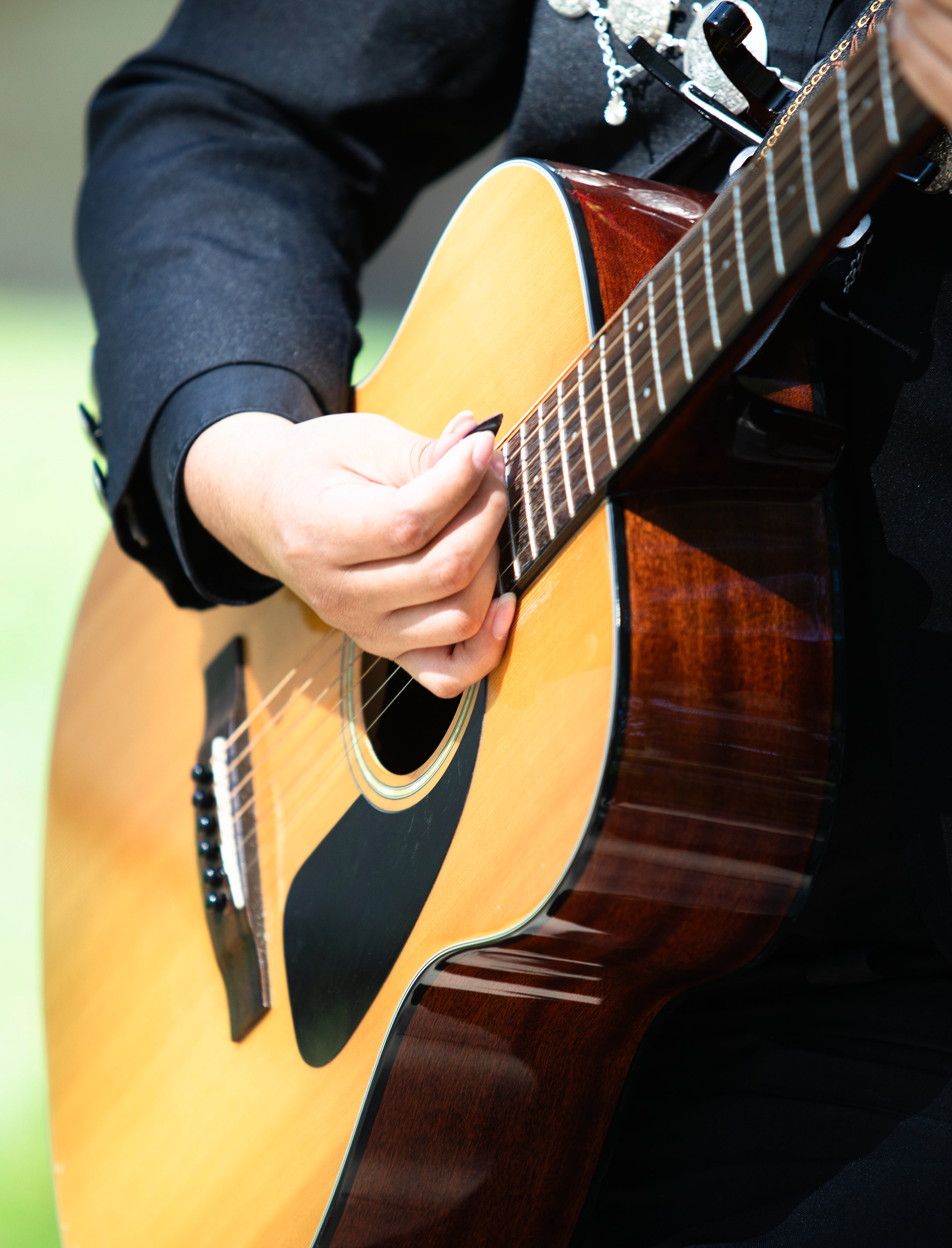 Elvis Vasquez, apart of Los Amigos band, plays guitar at different locations on campus Monday afternoon