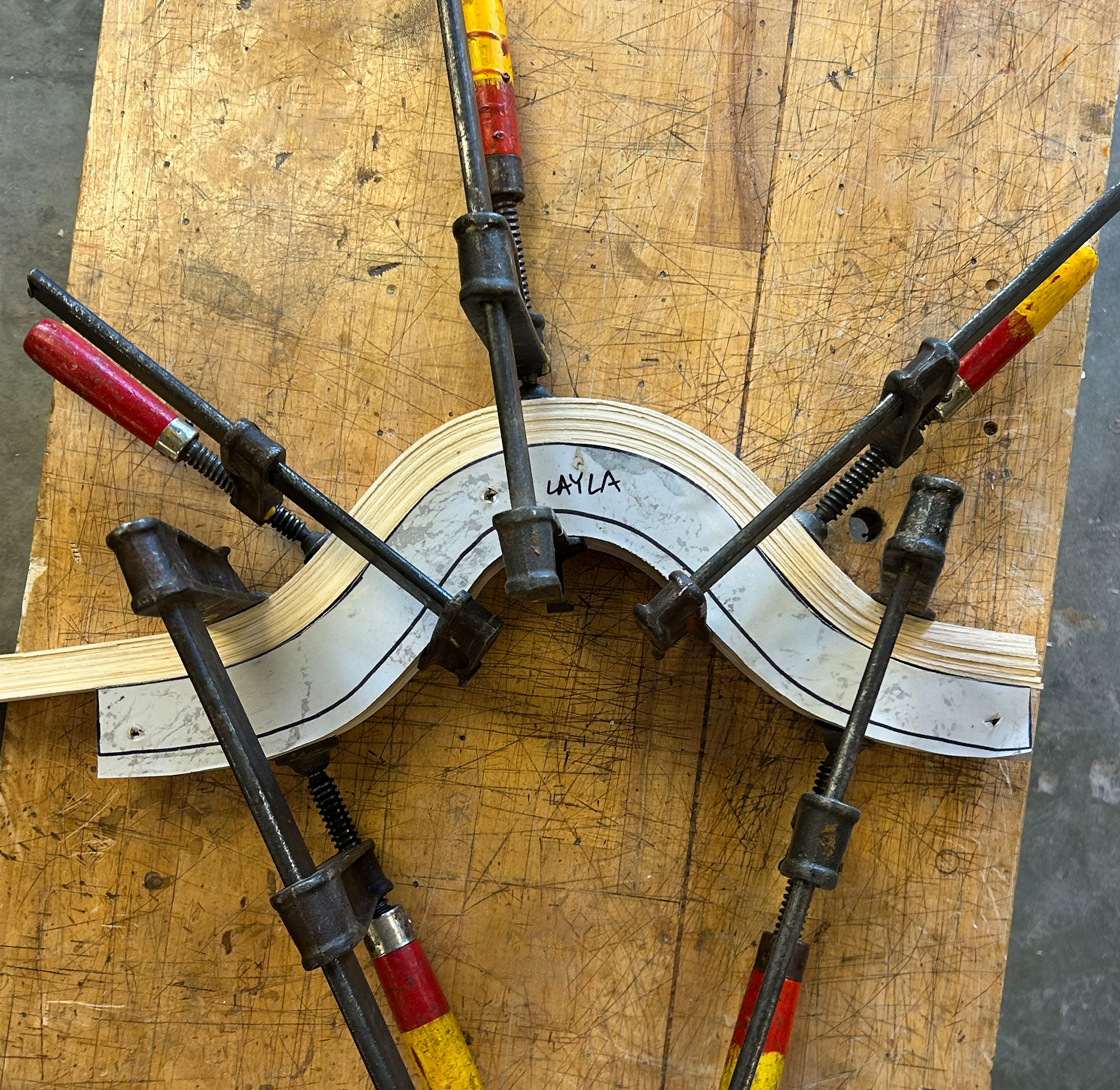 Steamed ash wood laminations clamped to set around custom sinusoidal LDF formwork