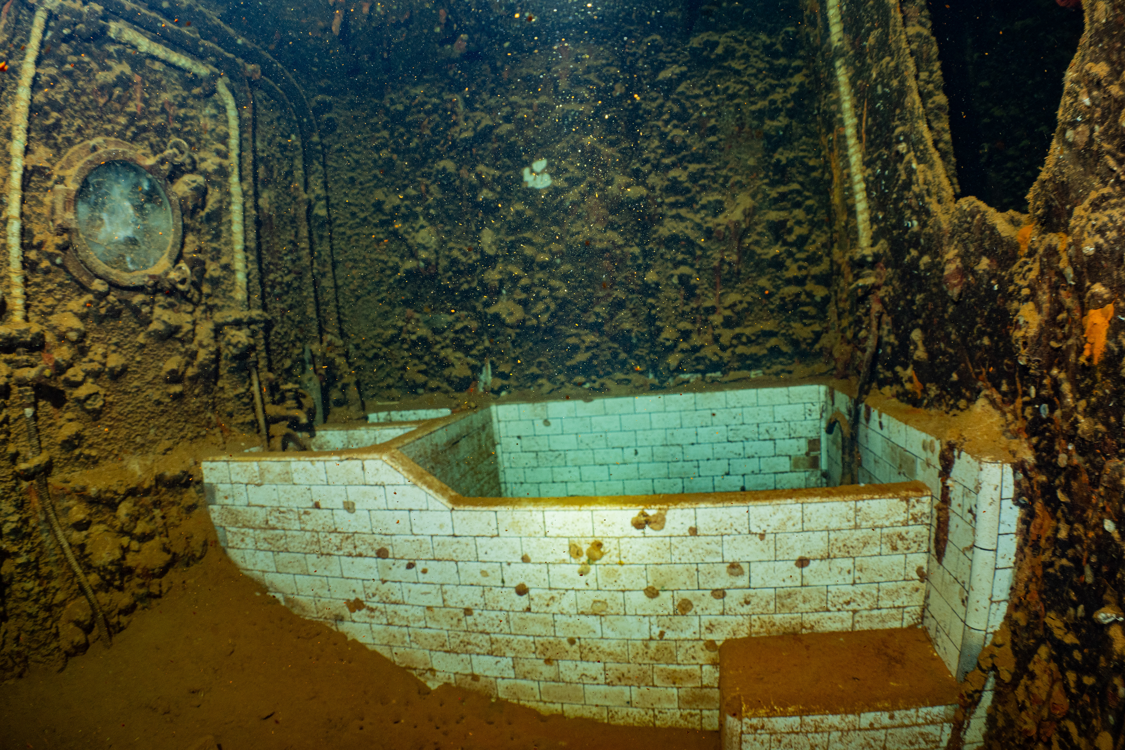 What seems to be officers bath, still showing nice white tile.