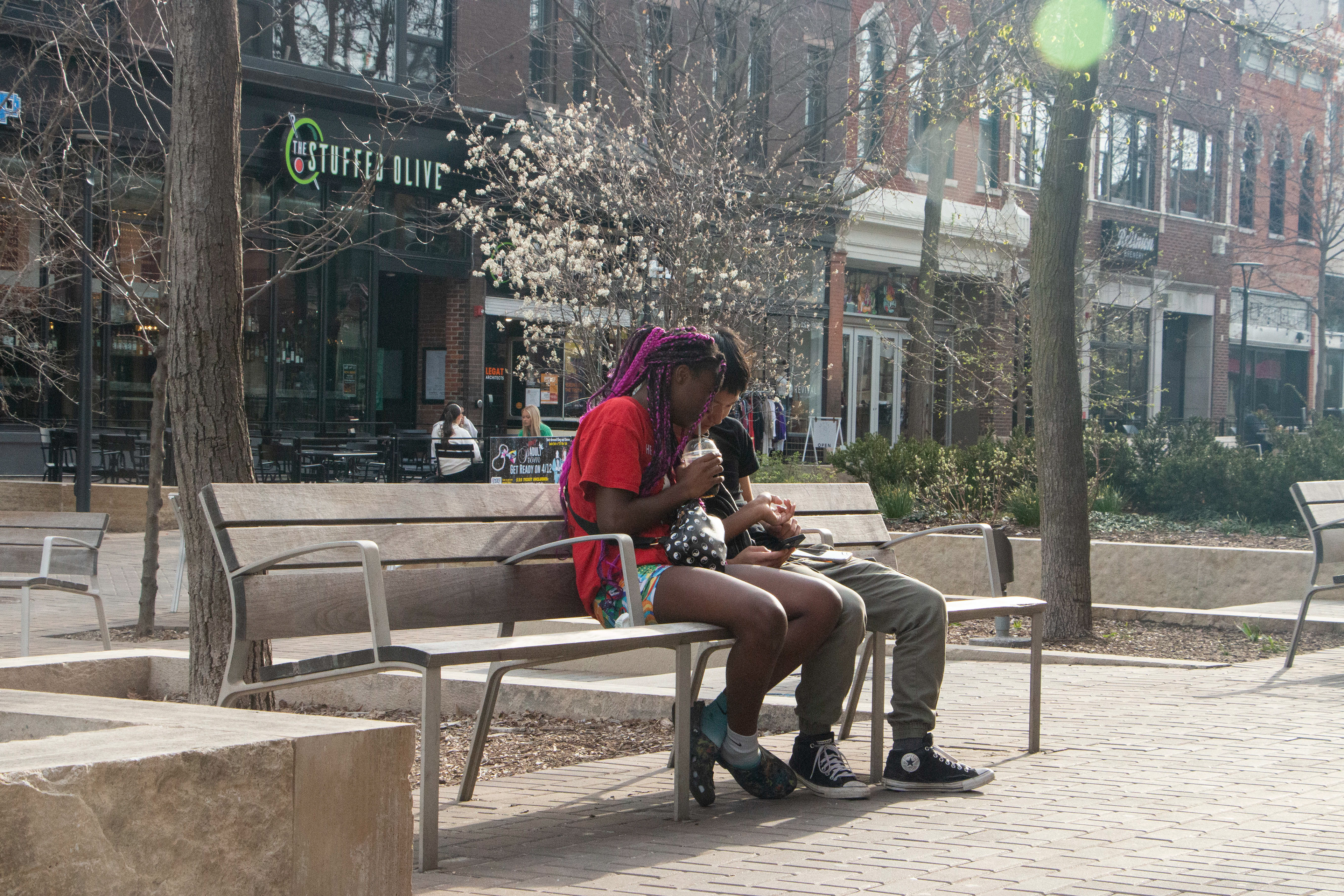 A teenage interracial couple hang out in the pedmall on April 10, 2024 in Downtown Iowa City, IA