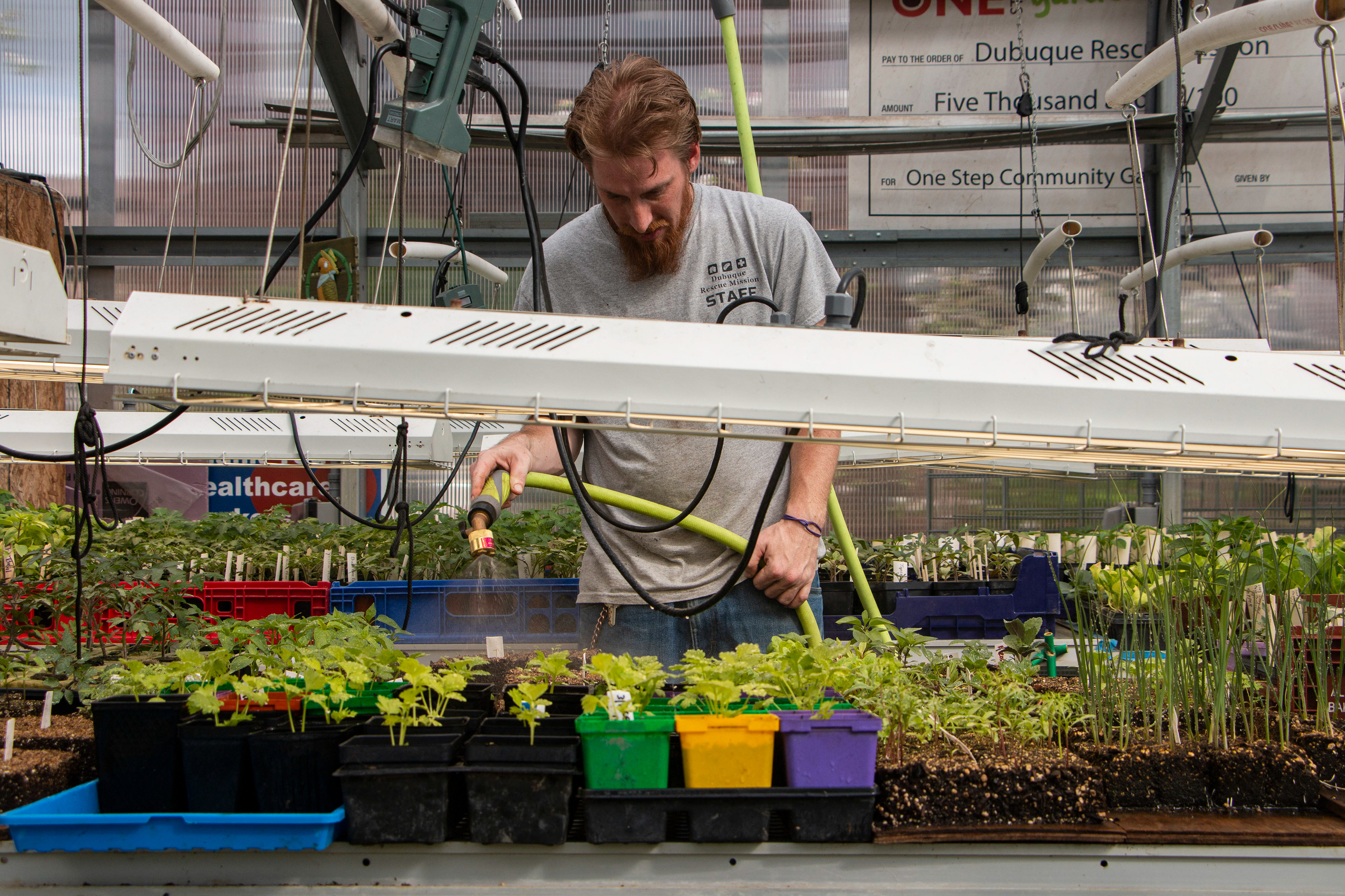 Rescue Mission Community Garden in Dubuque, IA on April 27, 2024. John Delventhal, the master gardener, waters the plants.