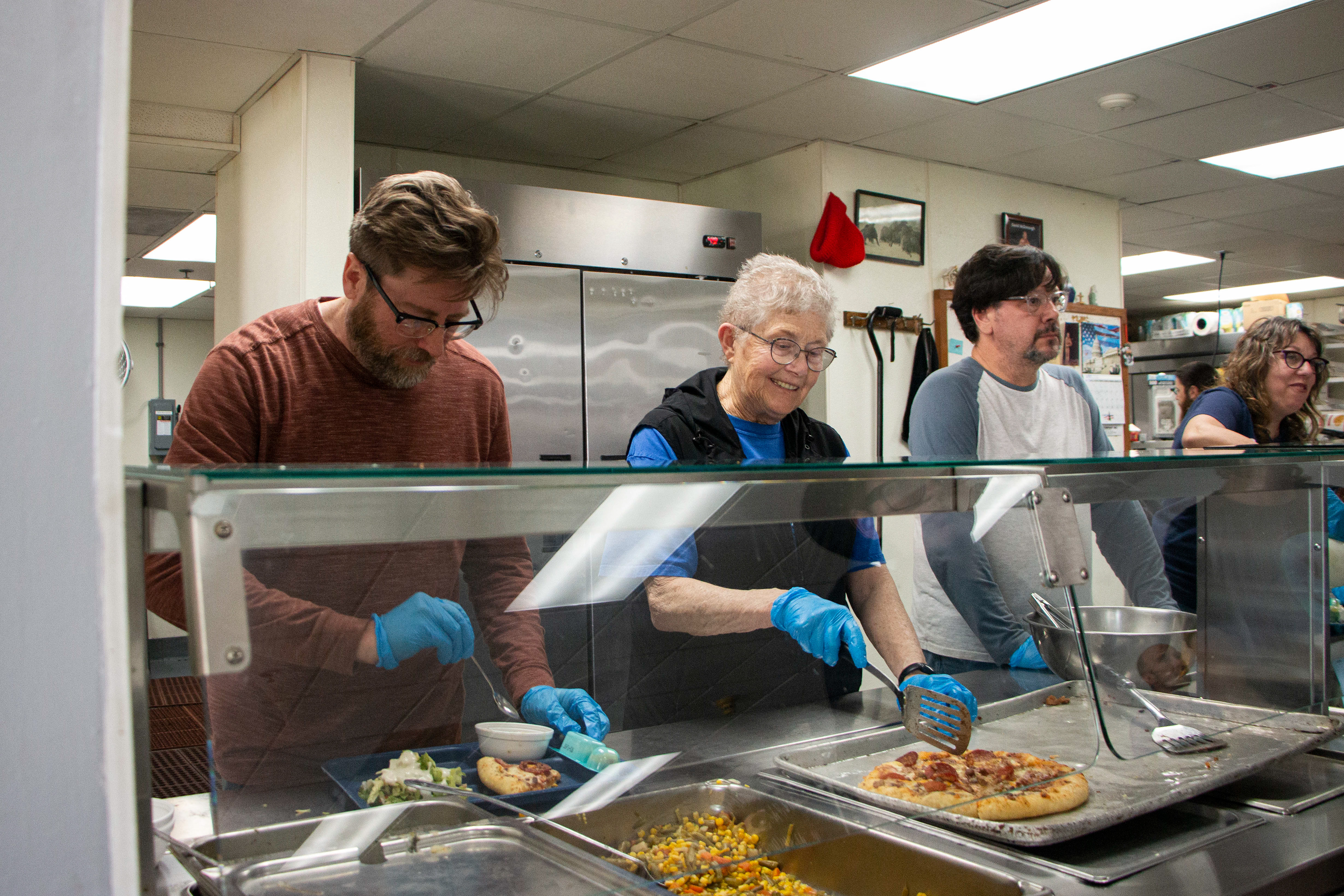 Rescue Mission Community Restaurant and Kitchen in Dubuque, IA on April 27, 2024. Mary Looney Bichelle, Jarry Hammel, Caroline Kopps and Todd Lange serve food.