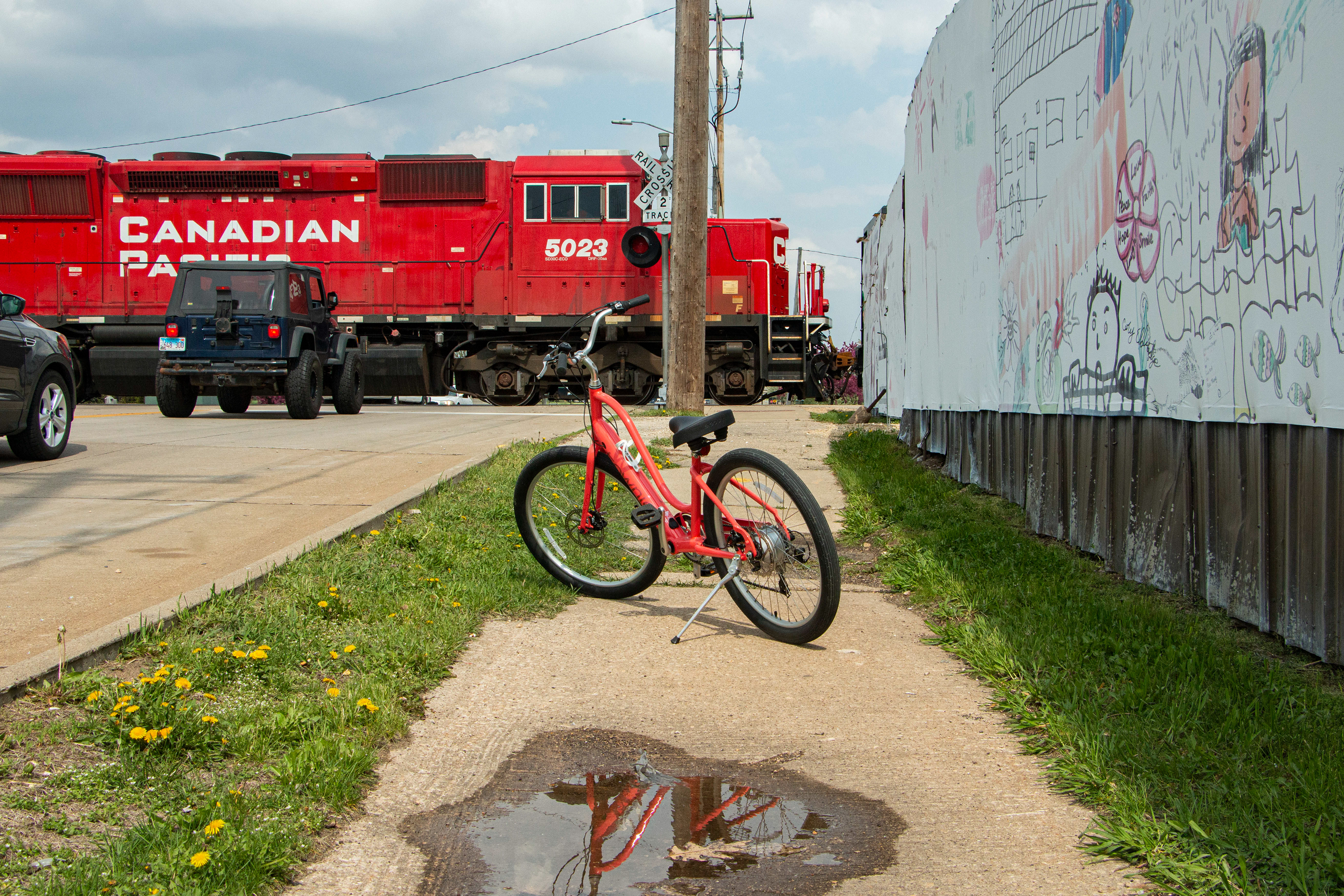 Dubuque, IA on April 27, 2024. Three means of transportation in Dubuque, Train, Car and Bicycle.