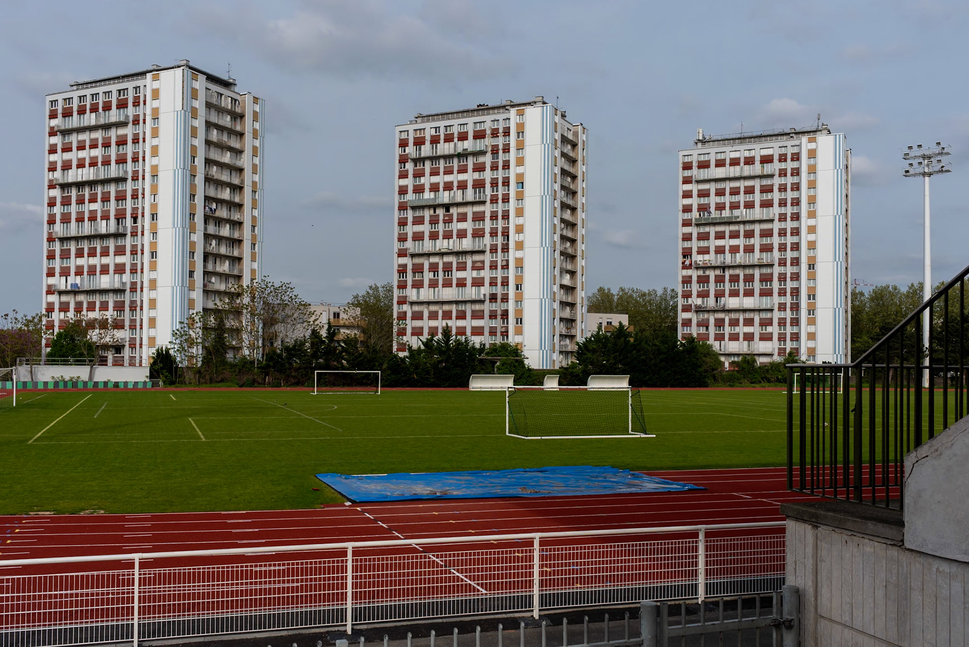 Three towers of 'Cité Marcel Paul' on Ile-Saint-Denis. The residential complex is situated between a training hall for athletes and the newly constructed Olympic villages. The houses are scheduled for demolition in 2025, and the remaining residents are facing pressure to leave their homes and relocate before the start of the Olympic Games. Paris, April 14, 2024.