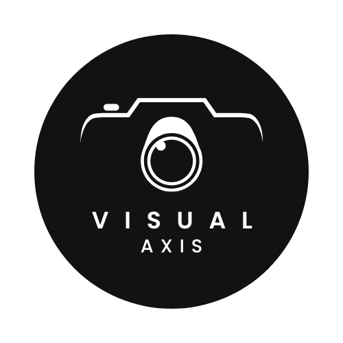 A black circular logo with a white outline of a camera at the top. Below the camera, the text reads "VISUAL" in bold, capitalized letters, followed by "AXIS" in smaller, spaced-out capital letters. The design is minimalist, emphasizing a sleek and modern feel for a photography-related business.