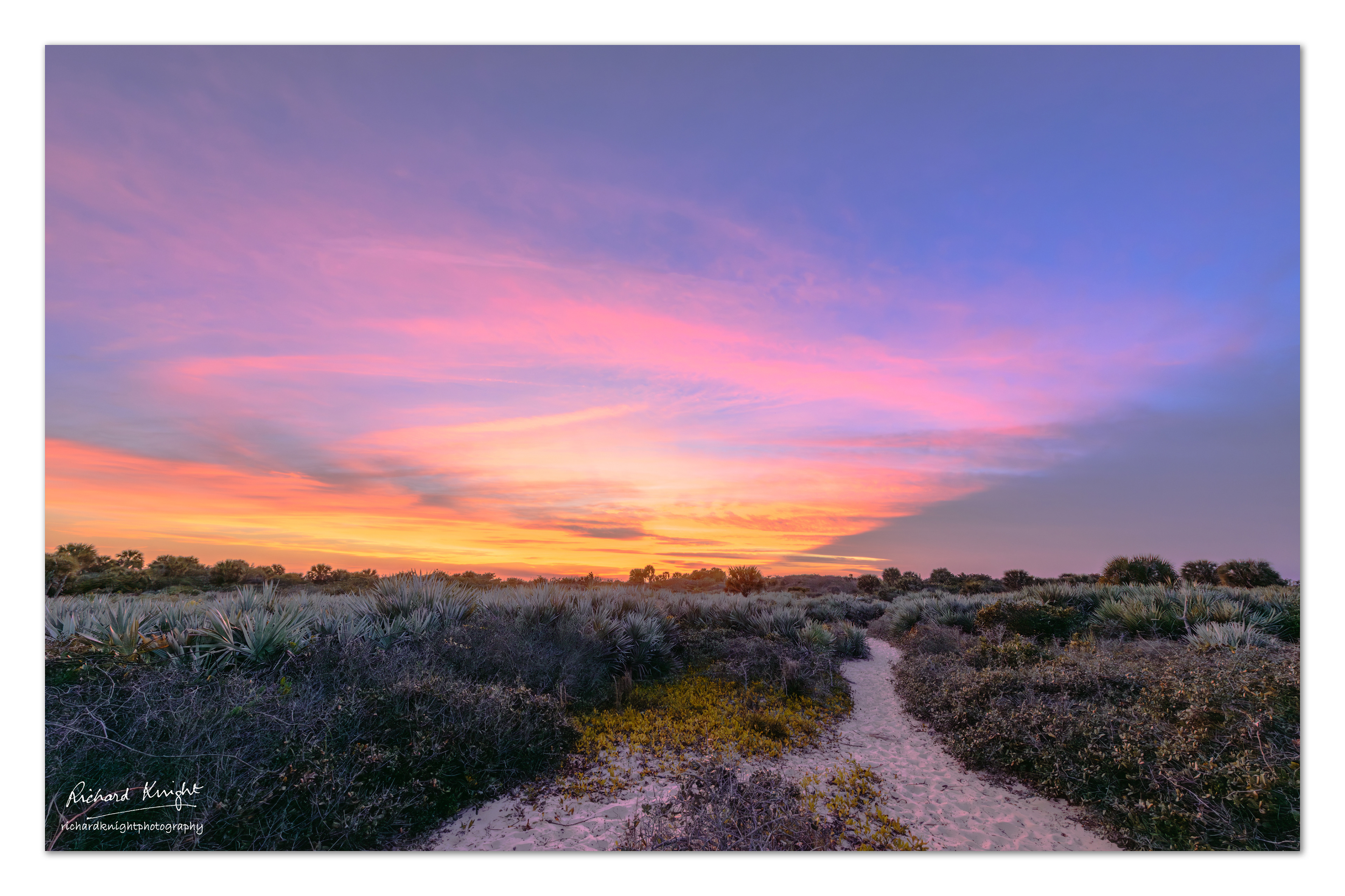A sandy footpath to a view