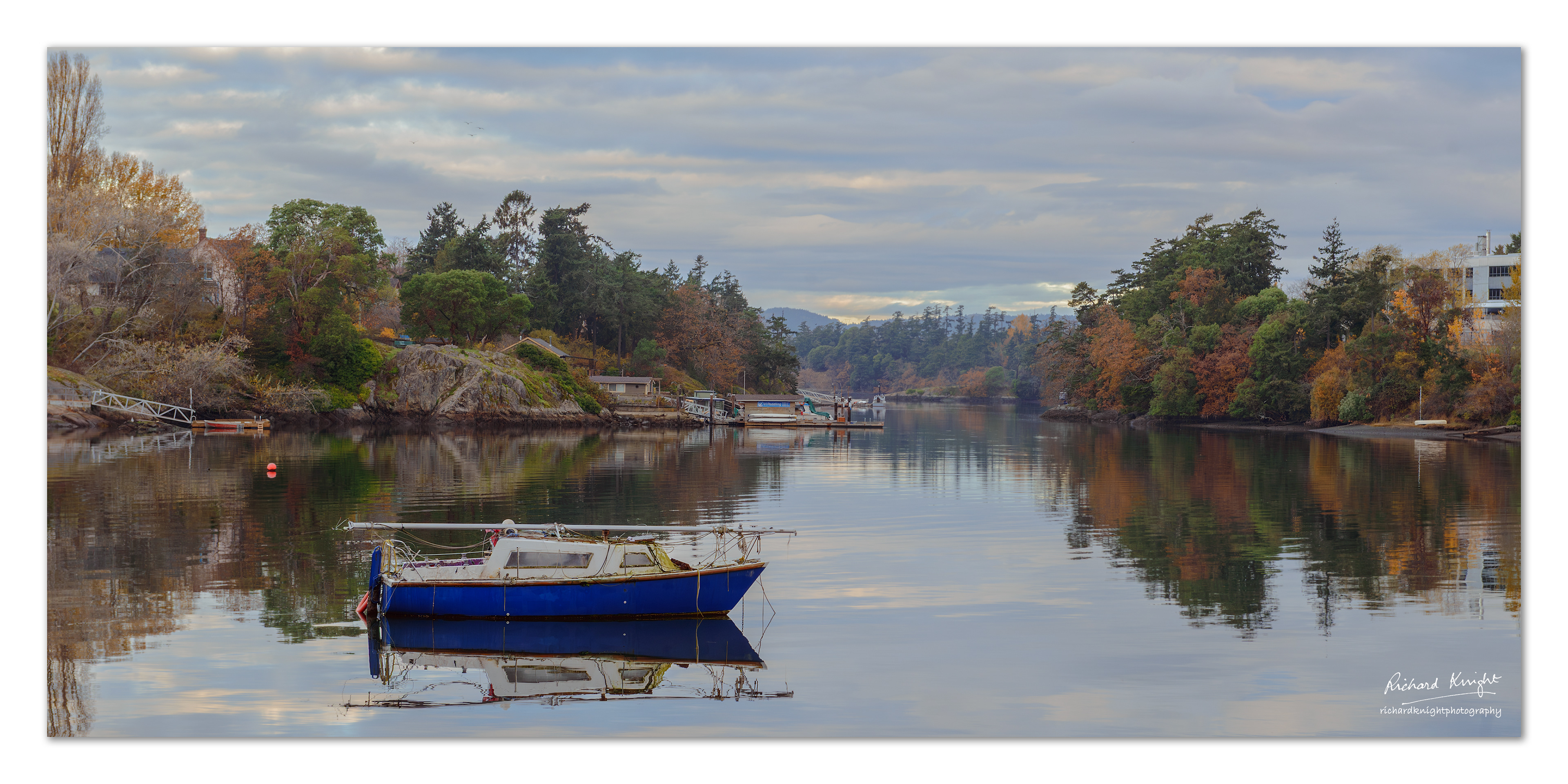 An old sailboat and its reflection north of Victoria