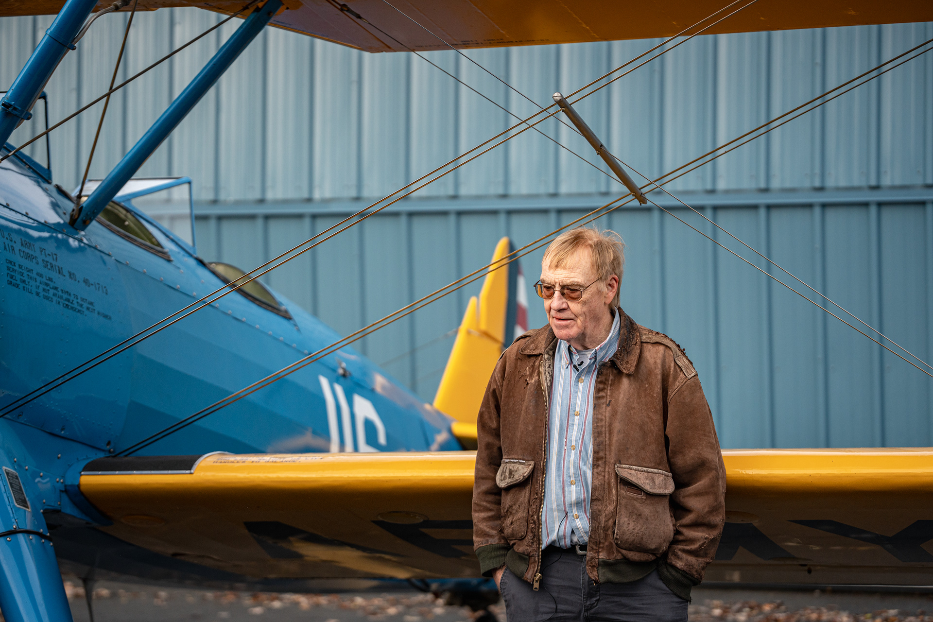 Bob Williams, semi-retired trial attorney and avid aviator, stands in front of his Steerman at the Skaneateles Aerodrome in New York