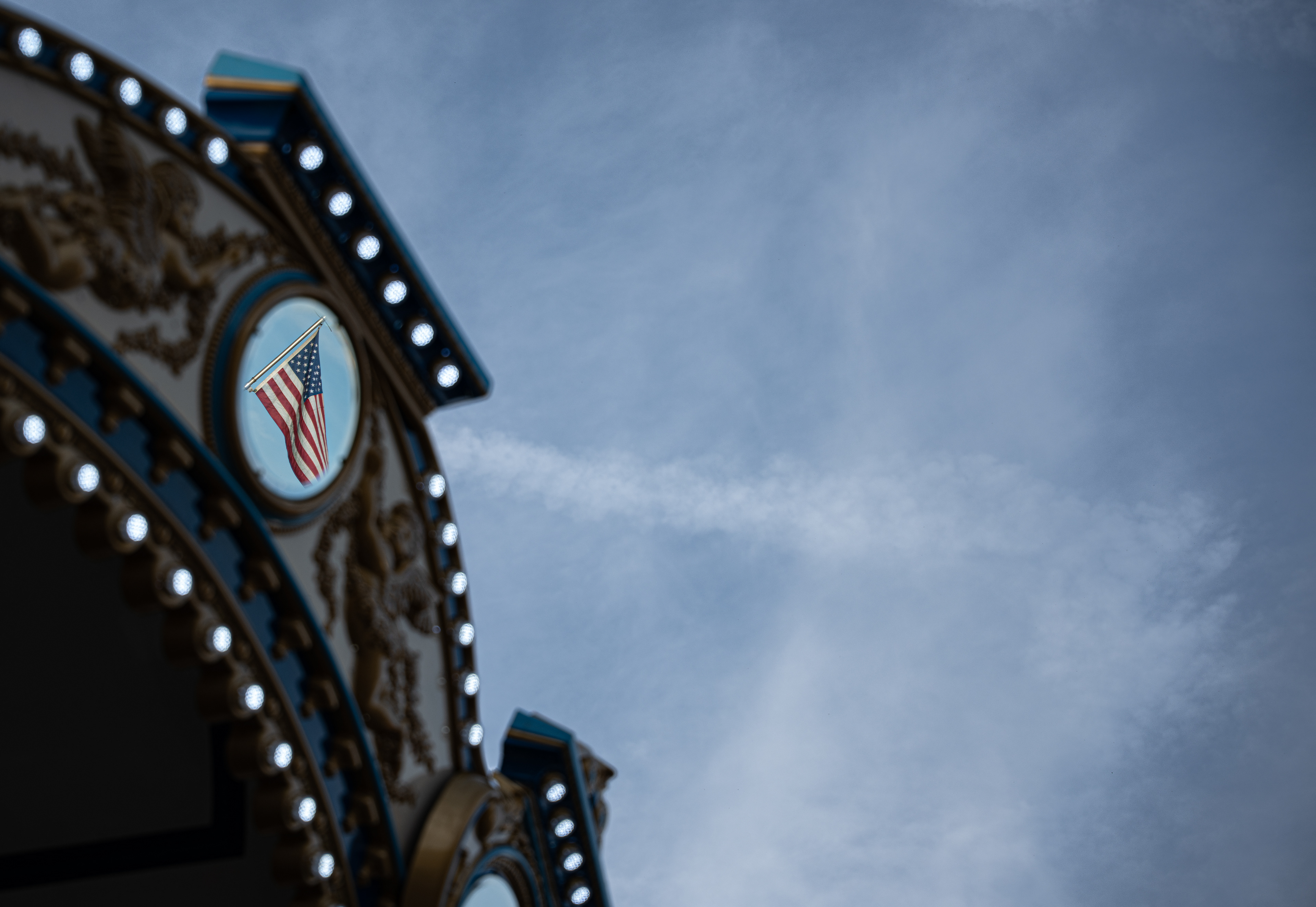 An American flag reflects off a carousel mirror at the Great New York State Fair.