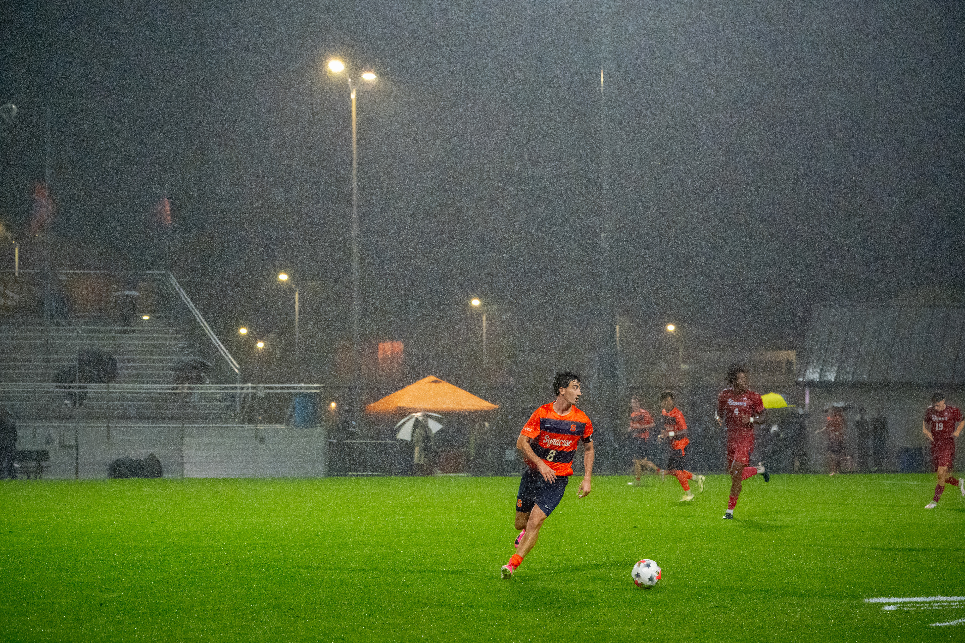 Syracuse midfielder Jackson Miller looks forward with the ball amongst heavy rain in Syracuse men's soccer's 5-1 win over St. Johns.