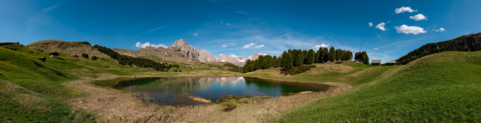 Panoramic view of Lago Santo and Seceda mountain in a sunny spring day.