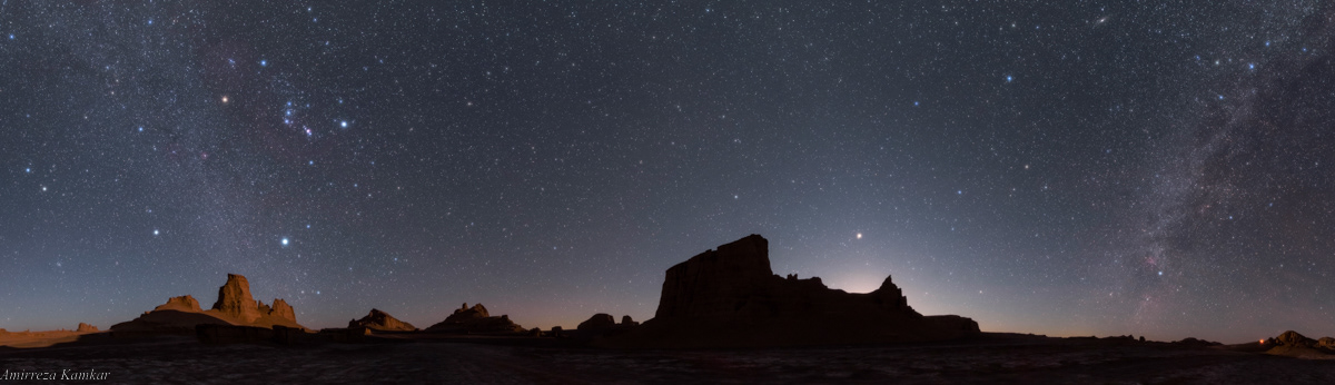 A panoramic view captured at the time of moonset in Lut Desert, Iran.