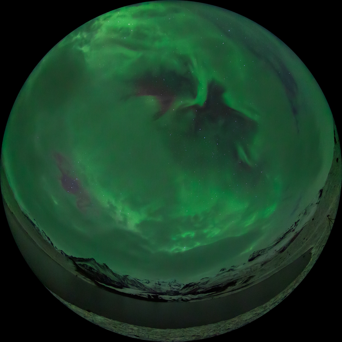 Fisheye image of northern light over a lake near Skaftafell glacier in Iceland.