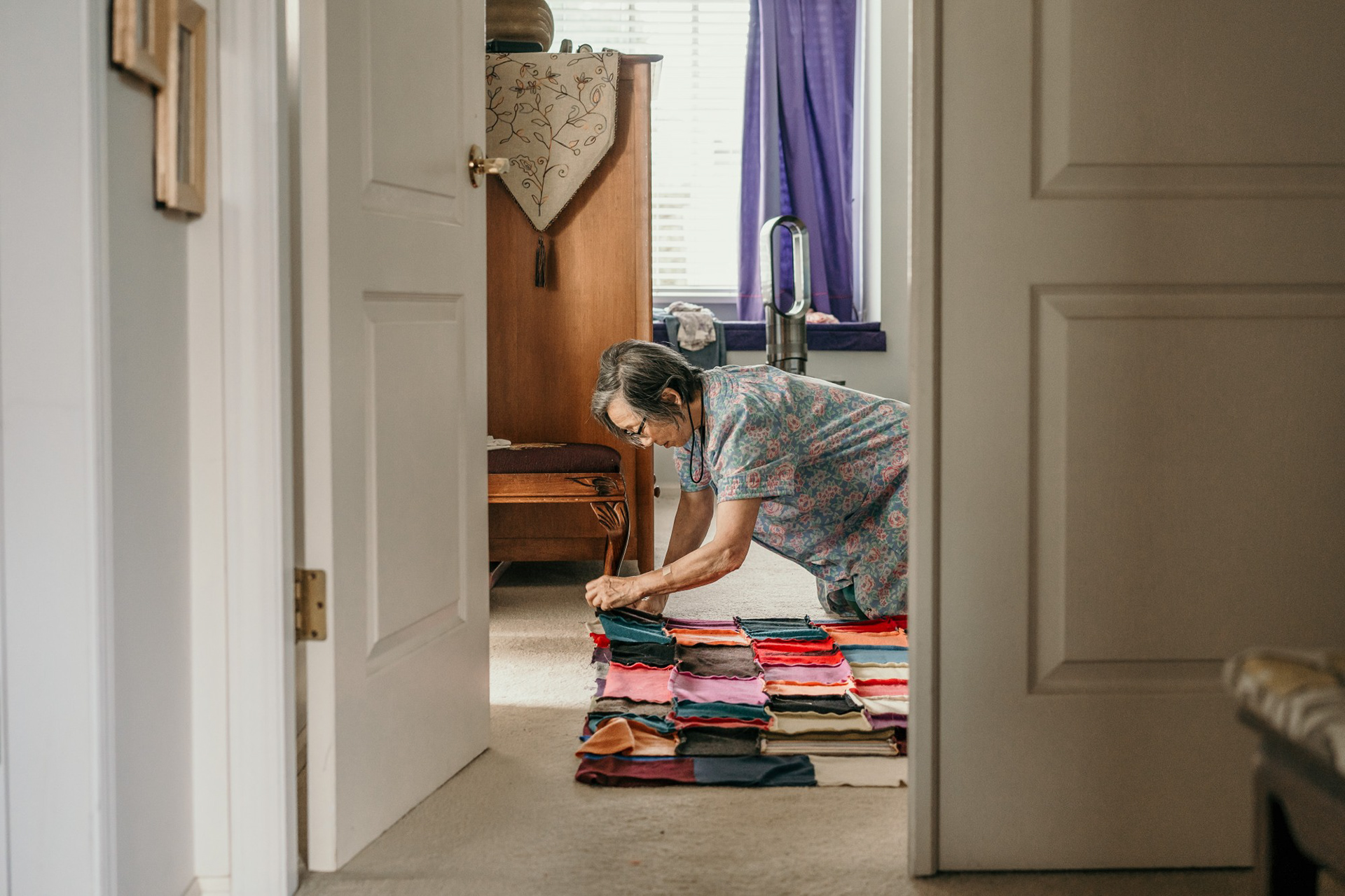 Vancouver, B.C.—Suzanne Louie sews a blanket made from repurposed cashmere scraps on the floor of her master bedroom. Photo by Kayla Isomura