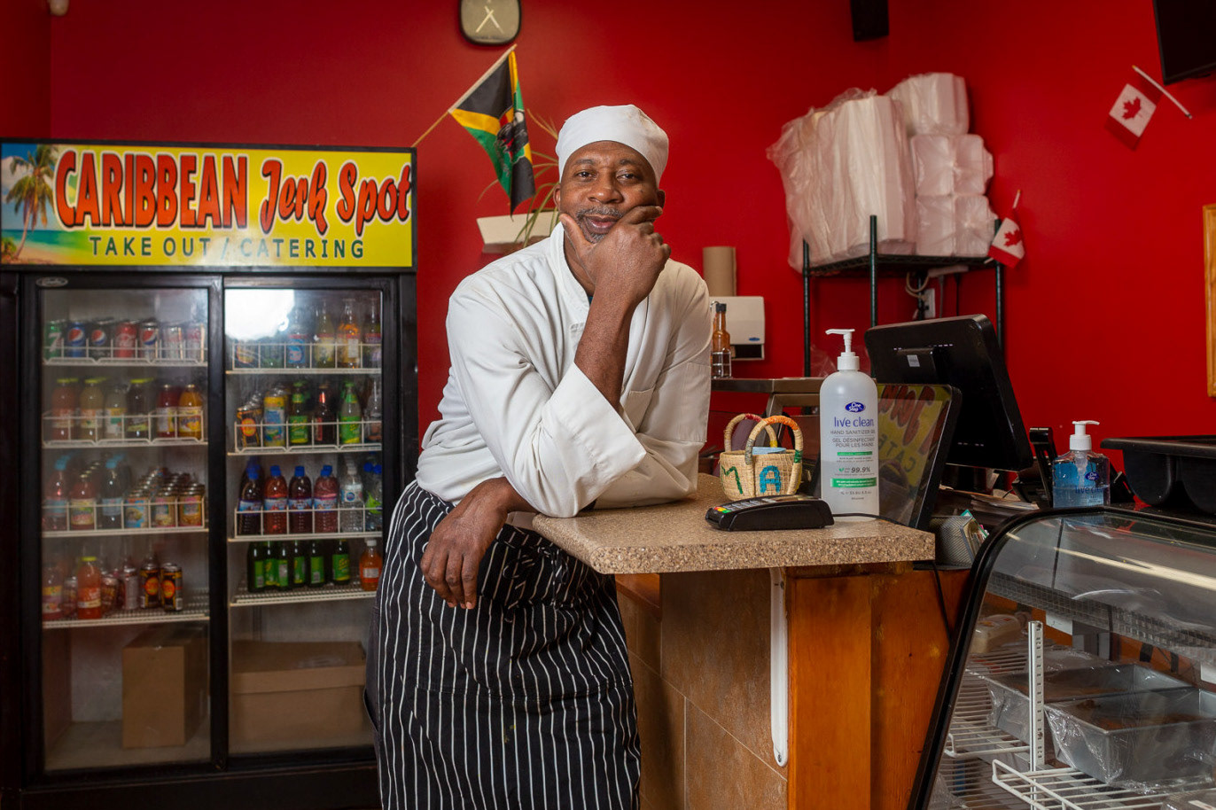 Belleville, Ont.—Devon Porter, 51, owner of the Caribbean Jerk Spot, leans against the front counter of the restaurant. The restaurant originally opened in 2018 but Porter only acquired it last year, fulfilling a life-long dream, he said. According to Porter, it was the first Caribbean restaurant to open in the city. What makes it unique, he said, is the authenticity of the food. His only challenge is some herbs and spices being milder in the area compared to what he would get in Jamaica. While Porter said the dishes at the Caribbean Jerk Spot are tasty, he prepares other dishes when he goes home for variety. “Definitely you eat something else when you go home,” he said. Photo by Kayla Isomura