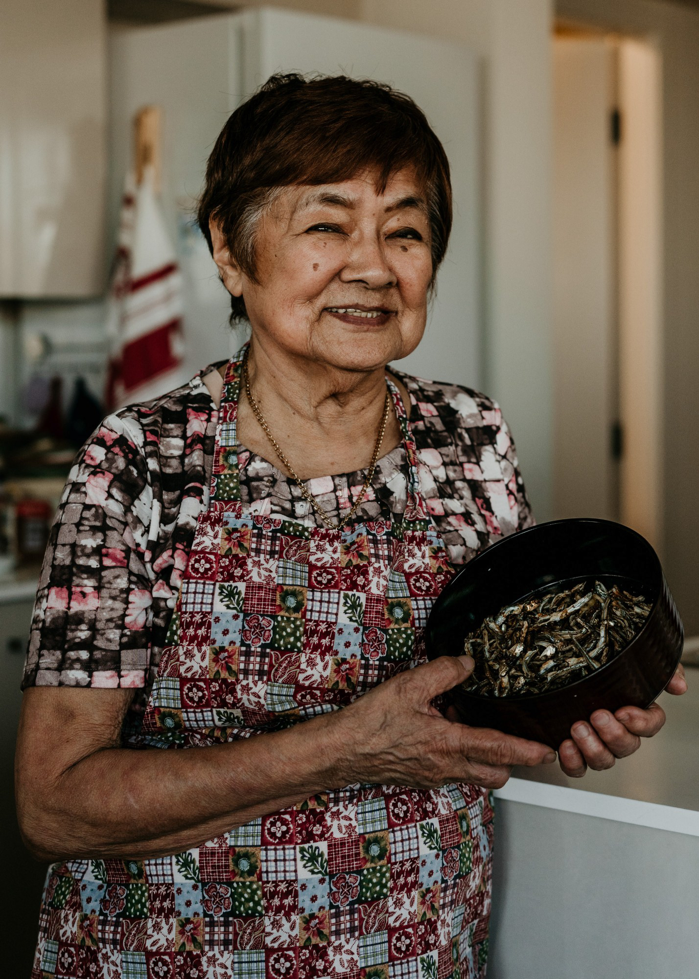 Richmond, B.C.—Fran Isomura holds bowl of dried sardines, one of many dishes eaten annually in Japanese culture New Year's. Photo by Kayla Isomura