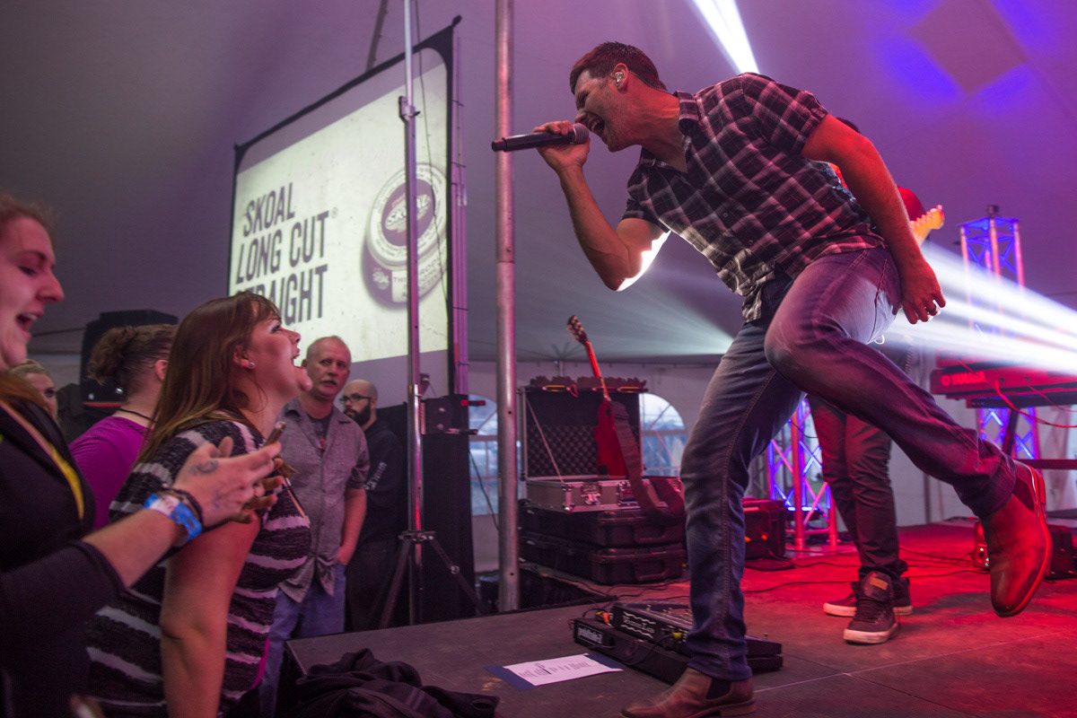 Vancouver, B.C.—Mike Allen and Katheryn Petersen peak outside of the Firehall Arts Centre as part of a physically distanced performance during the pandemic. The pair perform under the name Teapot in the Tuba, a “miniature circus-jazz orchestra.” Photo by Kayla Isomura