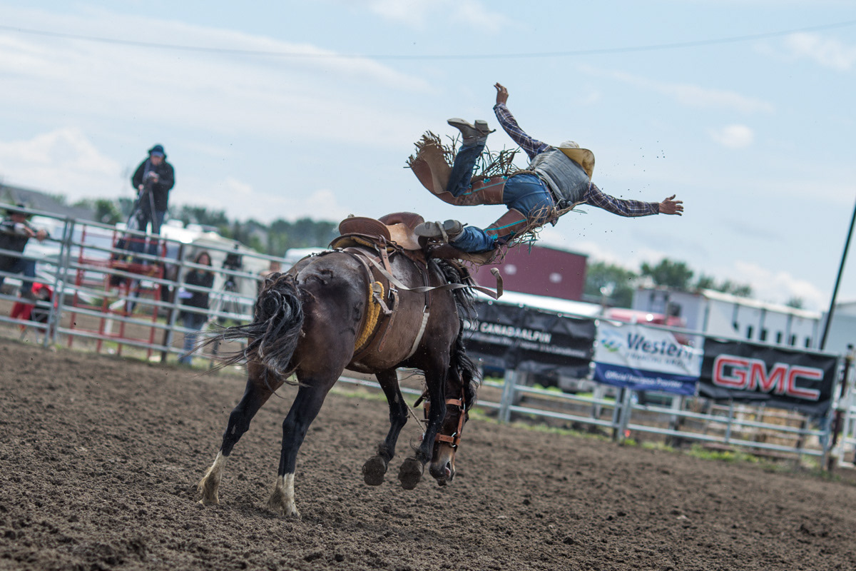 High River, Alta.—Colton Melby from Burneyville, Okla. is bucked from his horse in the final saddle bronc competition at Guy Weadick Days at the rodeo grounds. Photo by Kayla Isomura, as shot for the High River Times/Postmedia Network