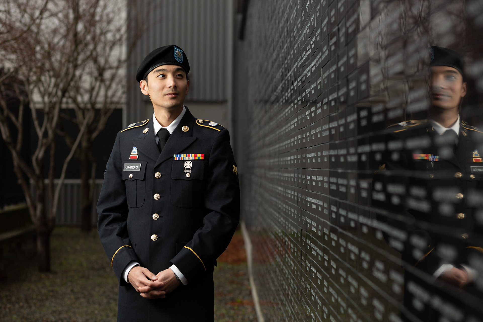 TJ Okamura stands near a memorial wall in Seattle, Wash. honouring Japanese Americans incarcerated during World War II and those who have served in the military. Currently a reservist, Okamura said both of his grandfathers’ decisions to serve during World War II, despite facing discrimination, inspired him to enlist in the U.S. Army.