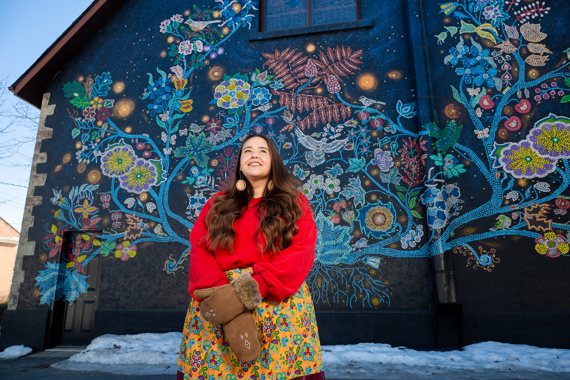 Picton, Ont.—Talitha Tolles, 29, stands in front of Wisdom of the Universe, a mural representing Métis beadwork based on an original painting by Christi Belcourt, behind St. Andrew’s Presbyterian Church. As a queer, Métis artist, Tolles said she experiences the complexities of identity daily but as a Métis woman, she said she has a commitment to her family and community to uphold traditions and to pass them on to future generations. This International Women’s Day, Tolles said breaking the bias means defying stereotypes. “Our world holds many forms of stereotypes and discrimination against women, but specifically Indigenous women. Every day I wake up and make the choice to defy those stereotypes,” she said. “My people are up against systems set out to eliminate us, and yet we continue to survive and in many cases thrive.” After moving to Prince Edward County, Tolles said the Wisdom of the Universe has made her feel both welcomed and at home.
