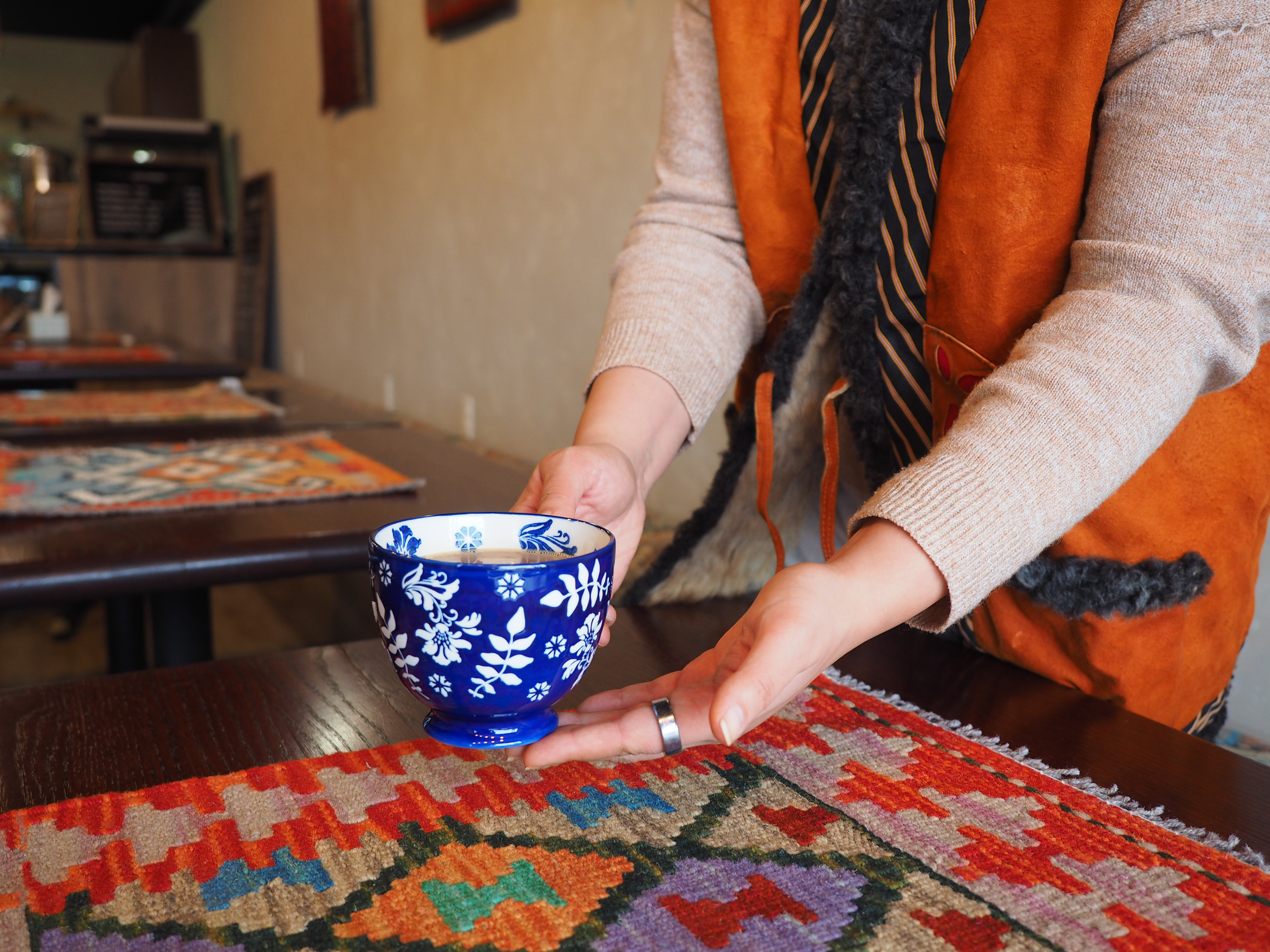 Nargis Orokzai serves tea Jan. 2026 at Kabul Corner in Bloomington, IN.