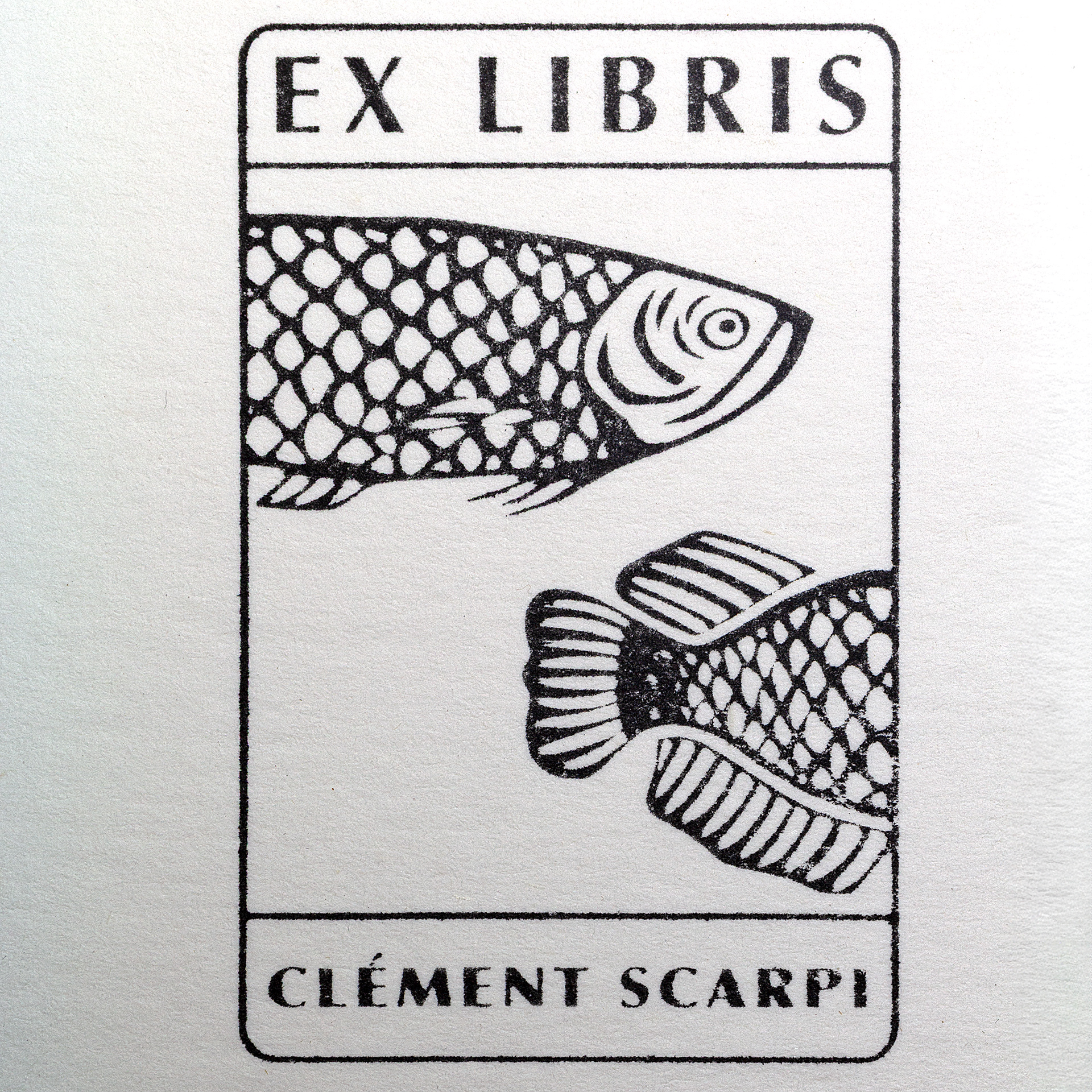 A black and white bookplate with EX LIBRIS at the top and CLÉMENT SCARPI at the bottom, featuring two stylized fish with scale patterns. 