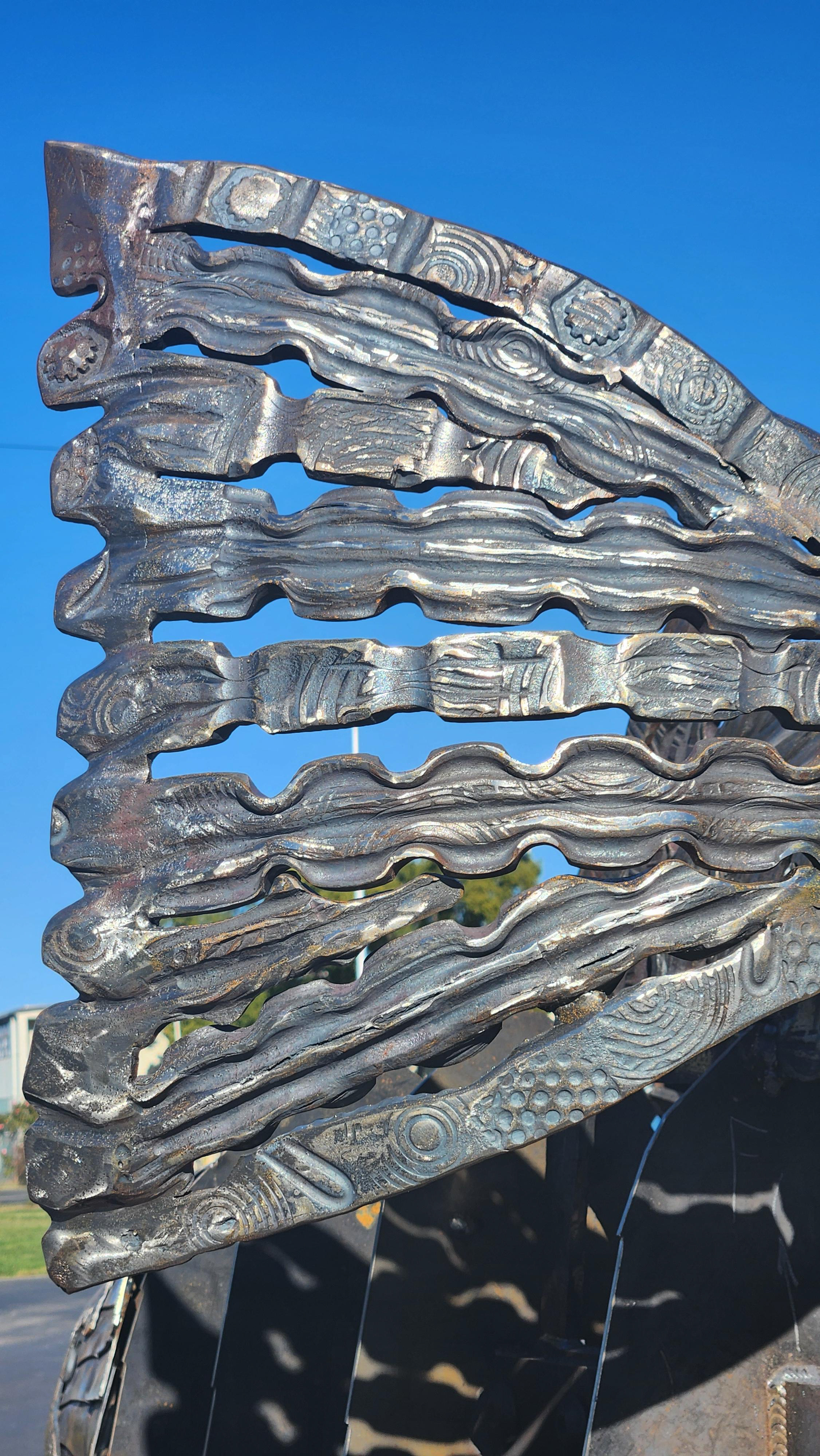 Picture taken of Sculpture at the Fair Grounds in Chico on a Trailer on Display for first public preview (Detail of the Sculptural detail of the Original Iron Rods from the Honey Run Bridge for the tail Fin)