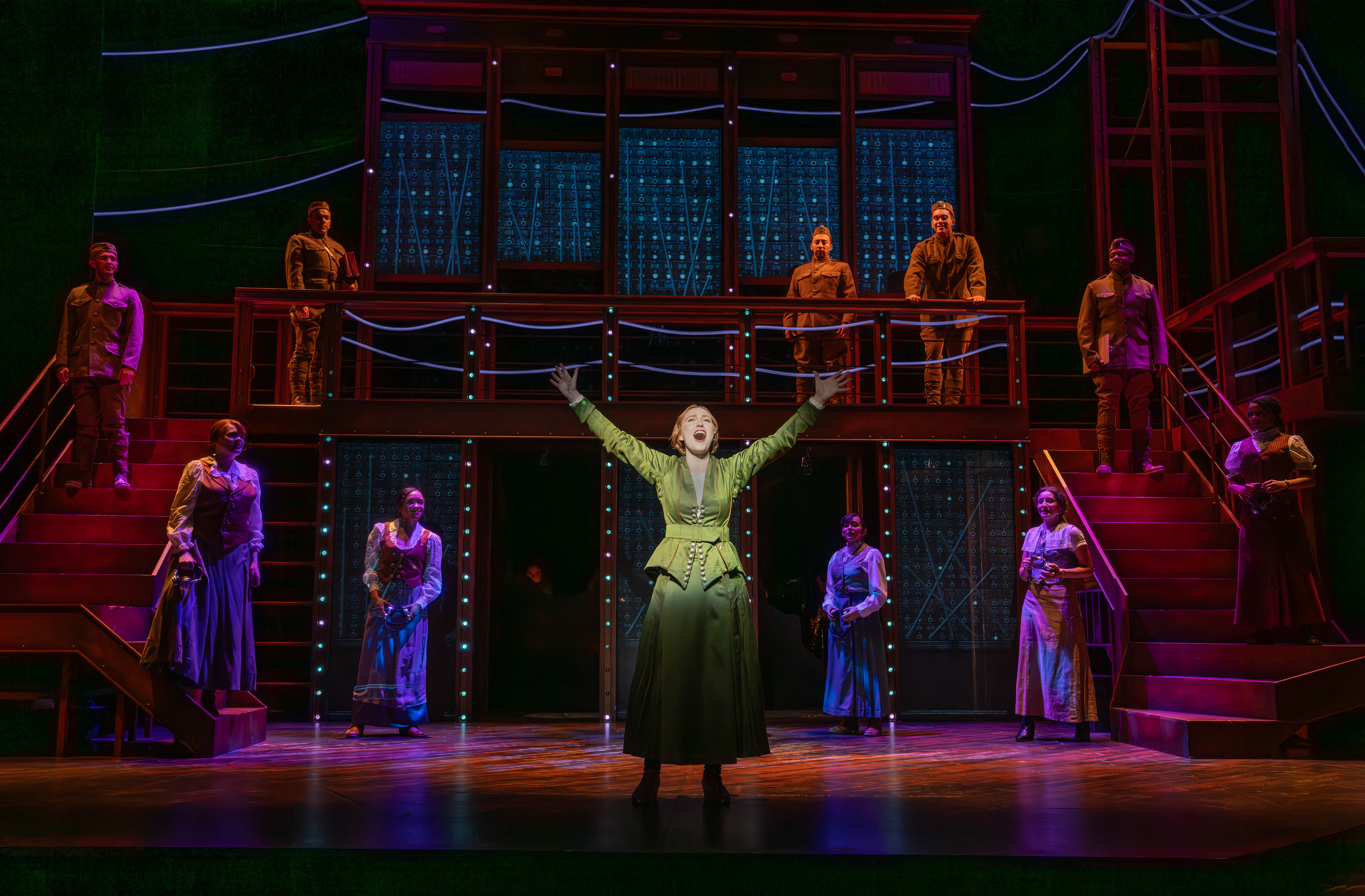 Chessa Metz (front) with cast members in the Syracuse Stage production of "The Hello Girls." September 9 - 28, 2025. Music and lyrics by Peter Mills. Book by Peter Mills and Cara Reichel. Directed by Cara Reichel. Co-produced with Michael Cassel Group, Broadway & Beyond Theatricals, and Chief Operator. Photo by Joan Marcus.