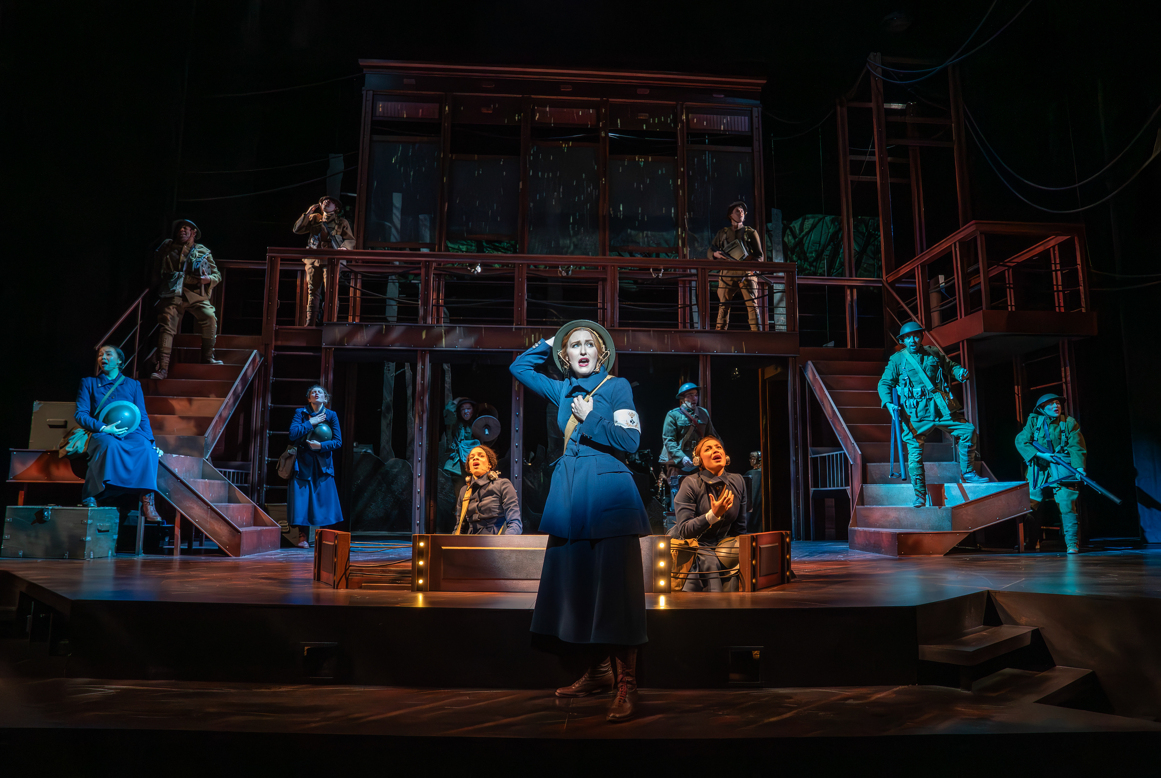 Chessa Metz (front) with cast members in the Syracuse Stage production of "The Hello Girls." September 9 - 28, 2025. Music and lyrics by Peter Mills. Book by Peter Mills and Cara Reichel. Directed by Cara Reichel. Co-produced with Michael Cassel Group, Broadway & Beyond Theatricals, and Chief Operator. Photo by Joan Marcus.