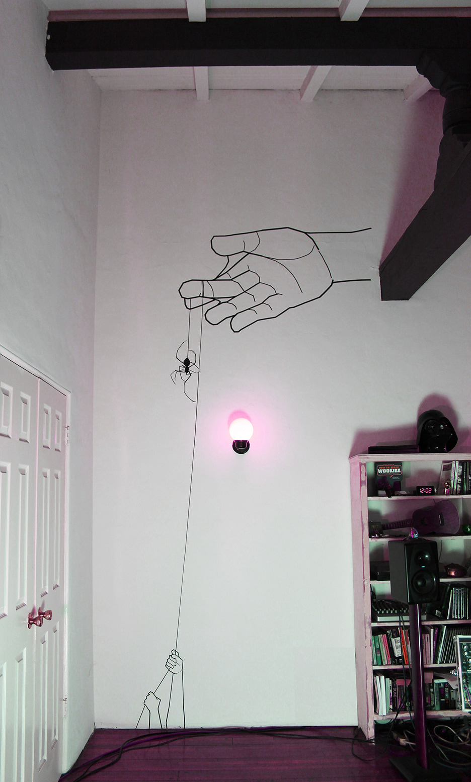 tape art mural installation Buddha hand, spider thread