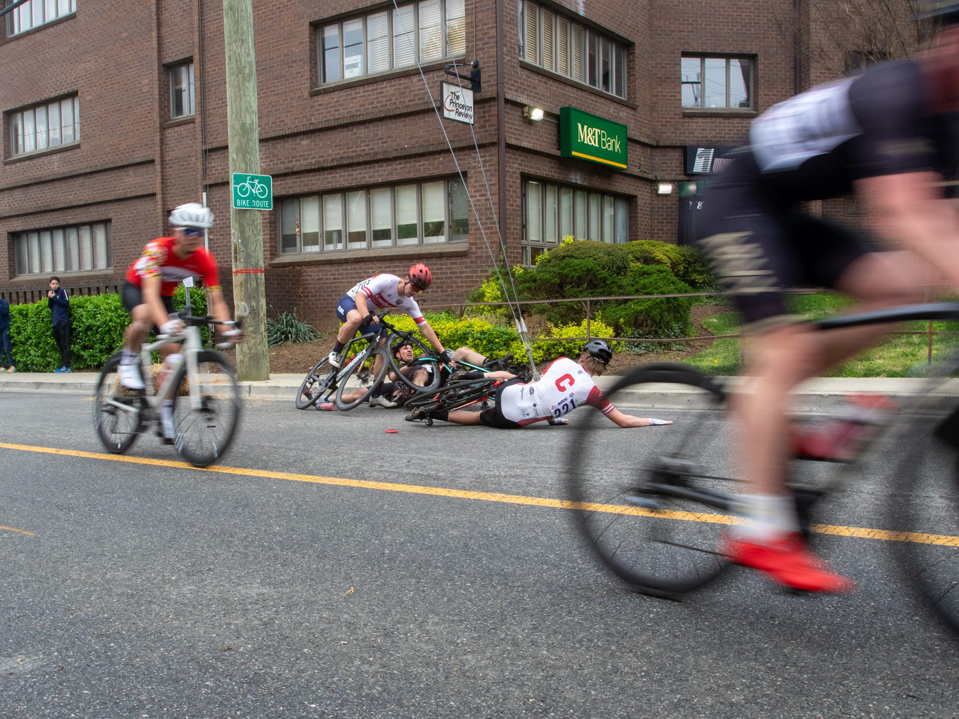 Three cyclists recover from a crash during the Route 1 Rampage on April 6, 2025..