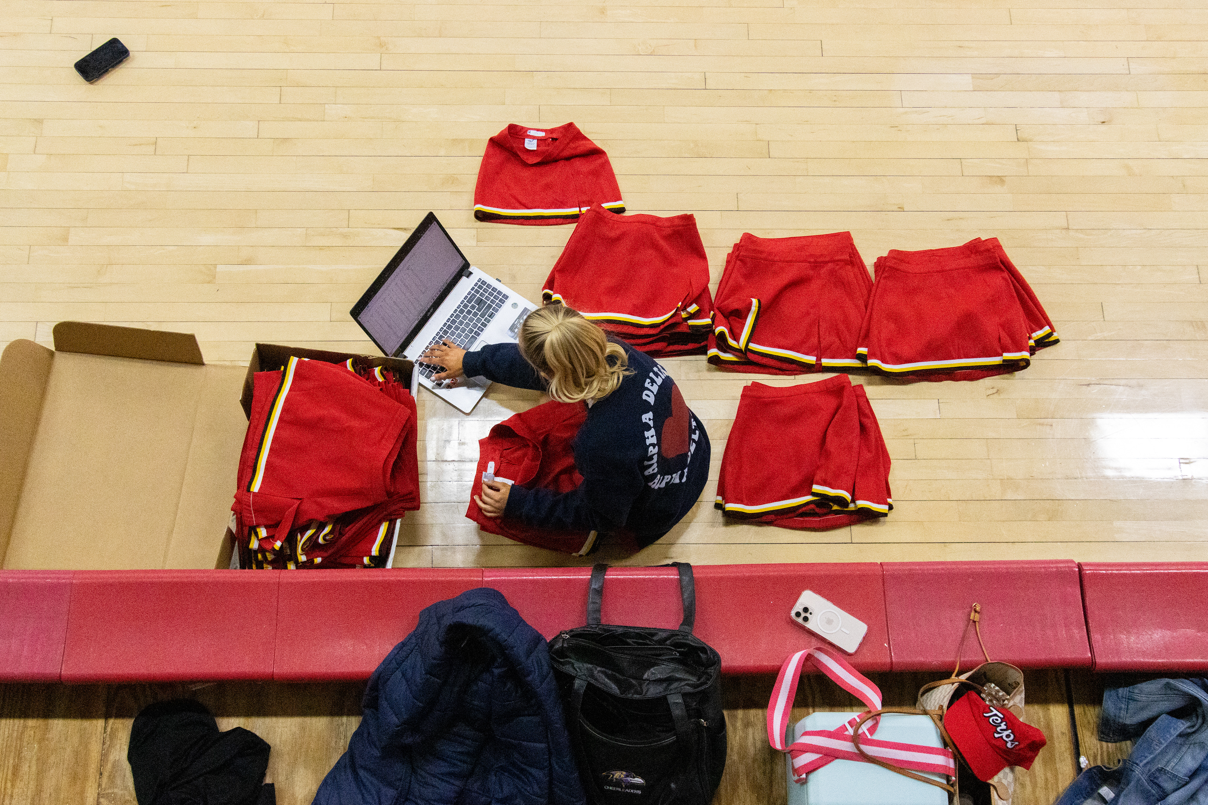 Senior Marissa Jarrett organizes new uniform skirts during practice on March 4, 2025. 