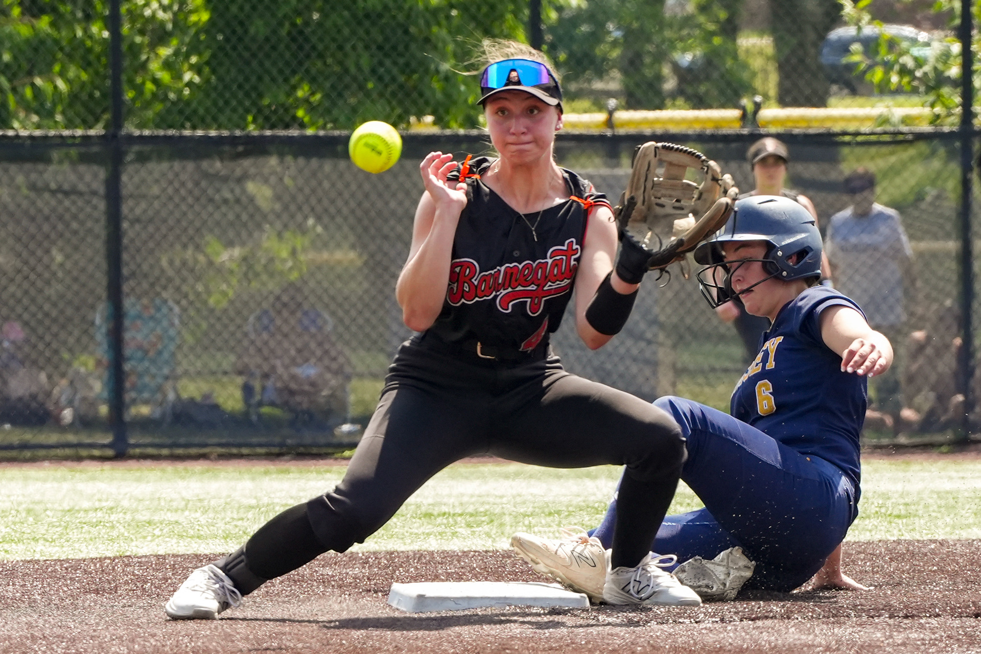 Barnegat sophomore Brooke Rizzo (4) prepares to catch the ball while Ramsey junior EJ Maurides (6) slides during Ramsey’s 8-1 win over Barnegat on Jun 12, 2026 at Ivy Hill Park in South Orange.