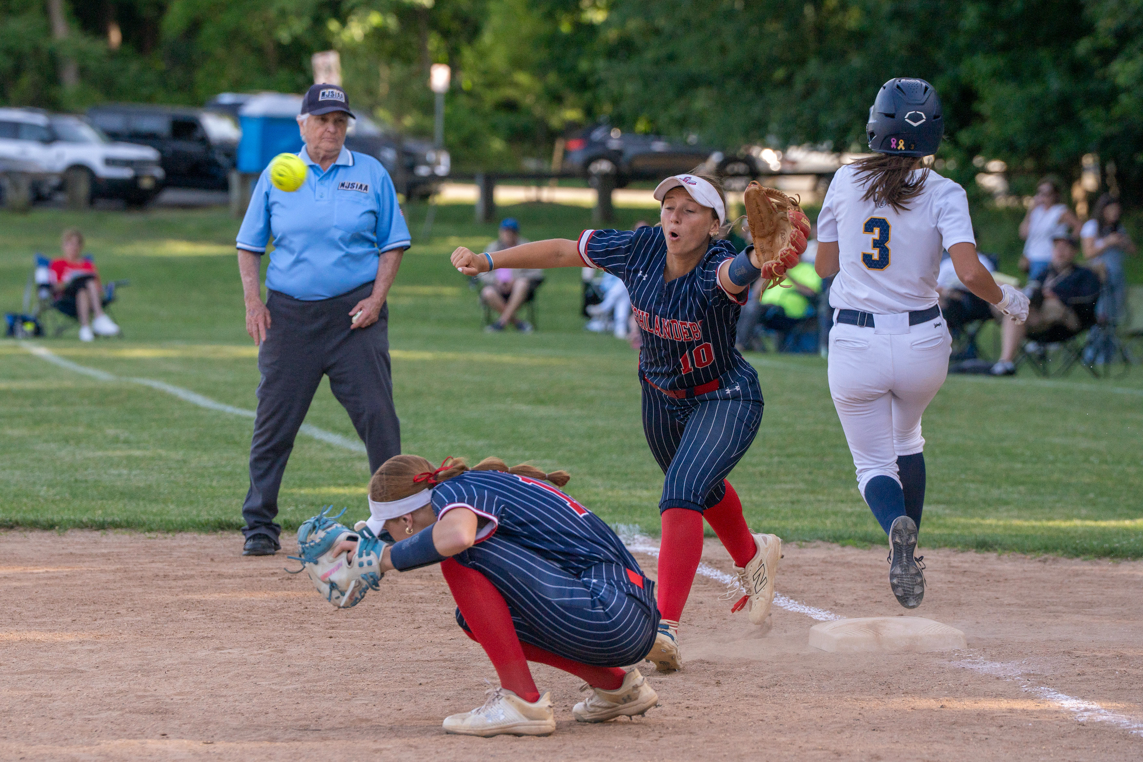 Governor Livingston senior Abbey Devanney (10) reaches for the ball as Ramsey senior Cynthia Chetaitis (3) passes first base during the softball group 2 semifinal on Jun 8, 2026 at Tisdale Elementary School in Ramsey.
