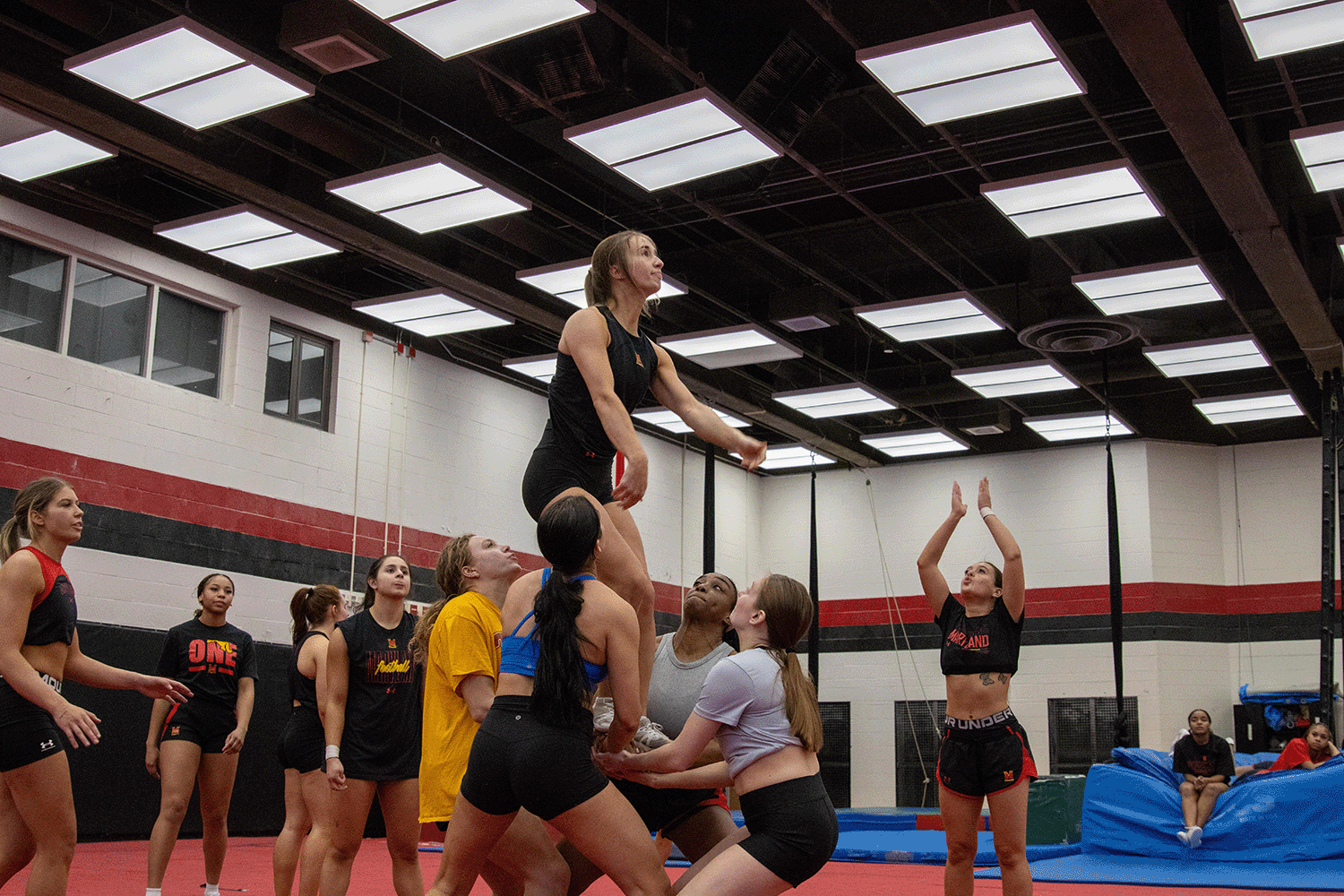 Maryland cheerleaders Natasha Slutzky, Kaelin Hibbs, Elizabeth Cornwell and Victoria Edozien complete a full twisting layout basket during practice in the public health school on March 10, 2025.